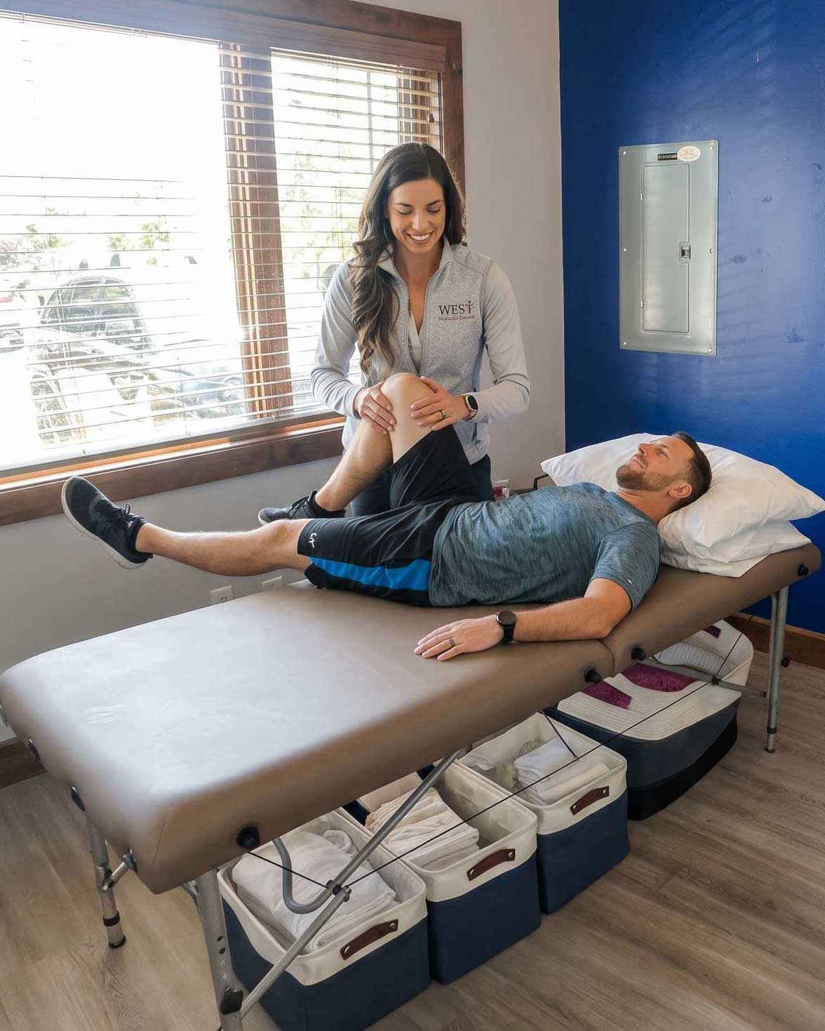Dr. Mackenzie working one-on-one with a patient during a physical therapy session