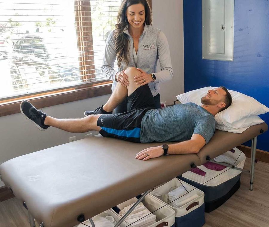 Dr. Mackenzie working one-on-one with a patient during a physical therapy session