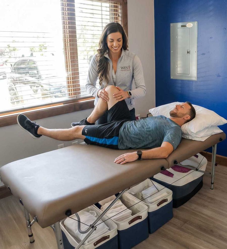 Dr. Mackenzie working one-on-one with a patient during a physical therapy session