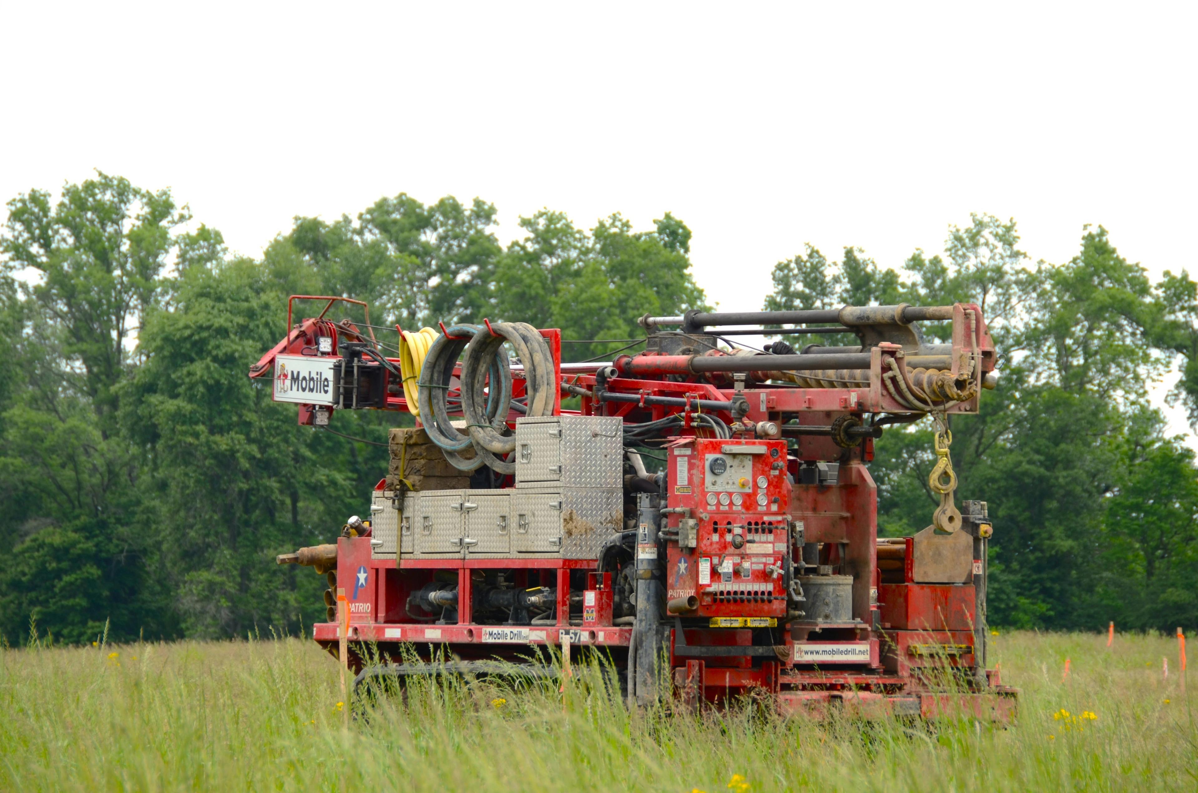 Track driven mobile drill rig in field