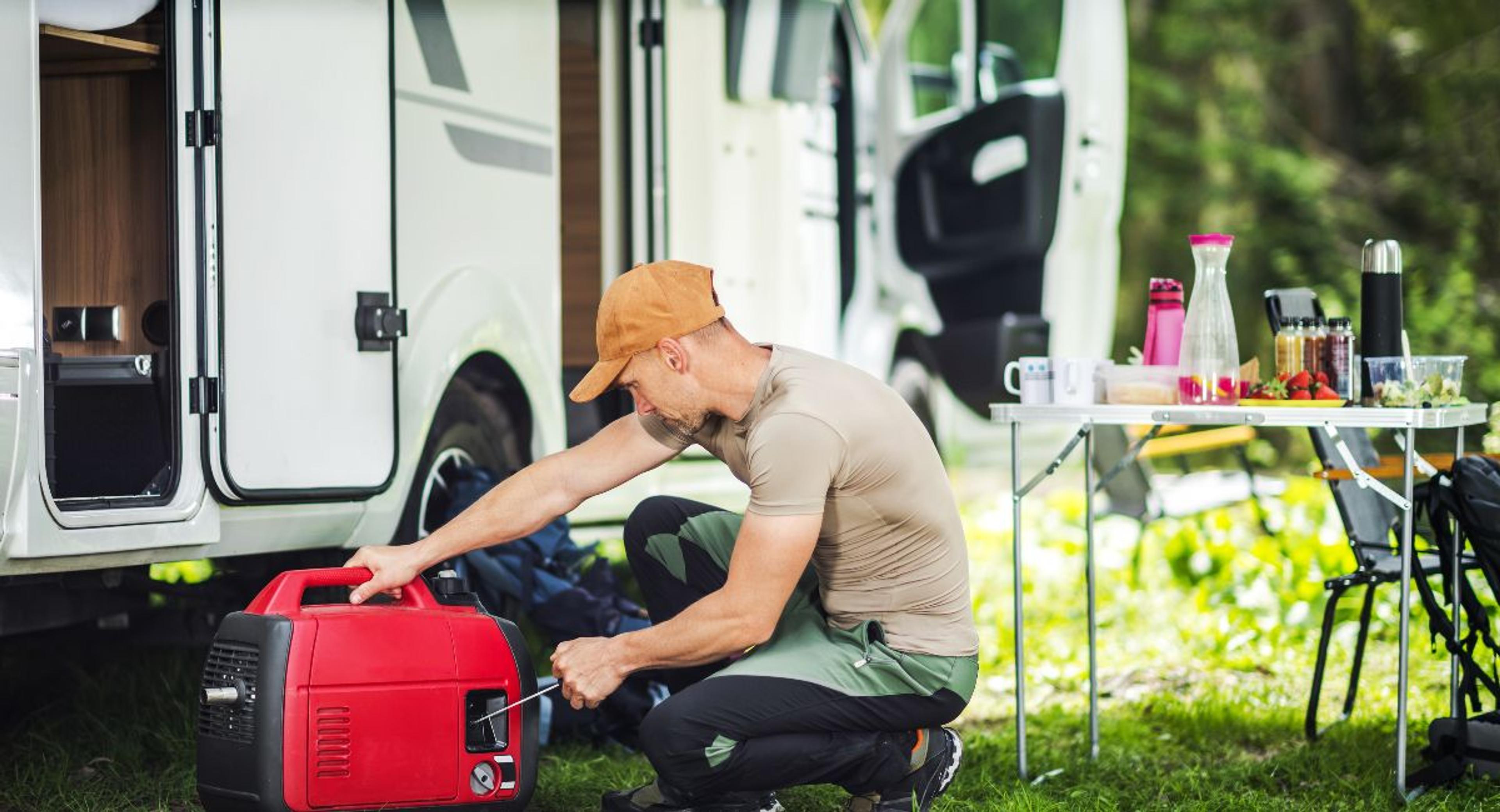 RV Traveler inspecting a battery pack and power generator by His Motorhome While Setting Up for a Stay at Camping Spot.