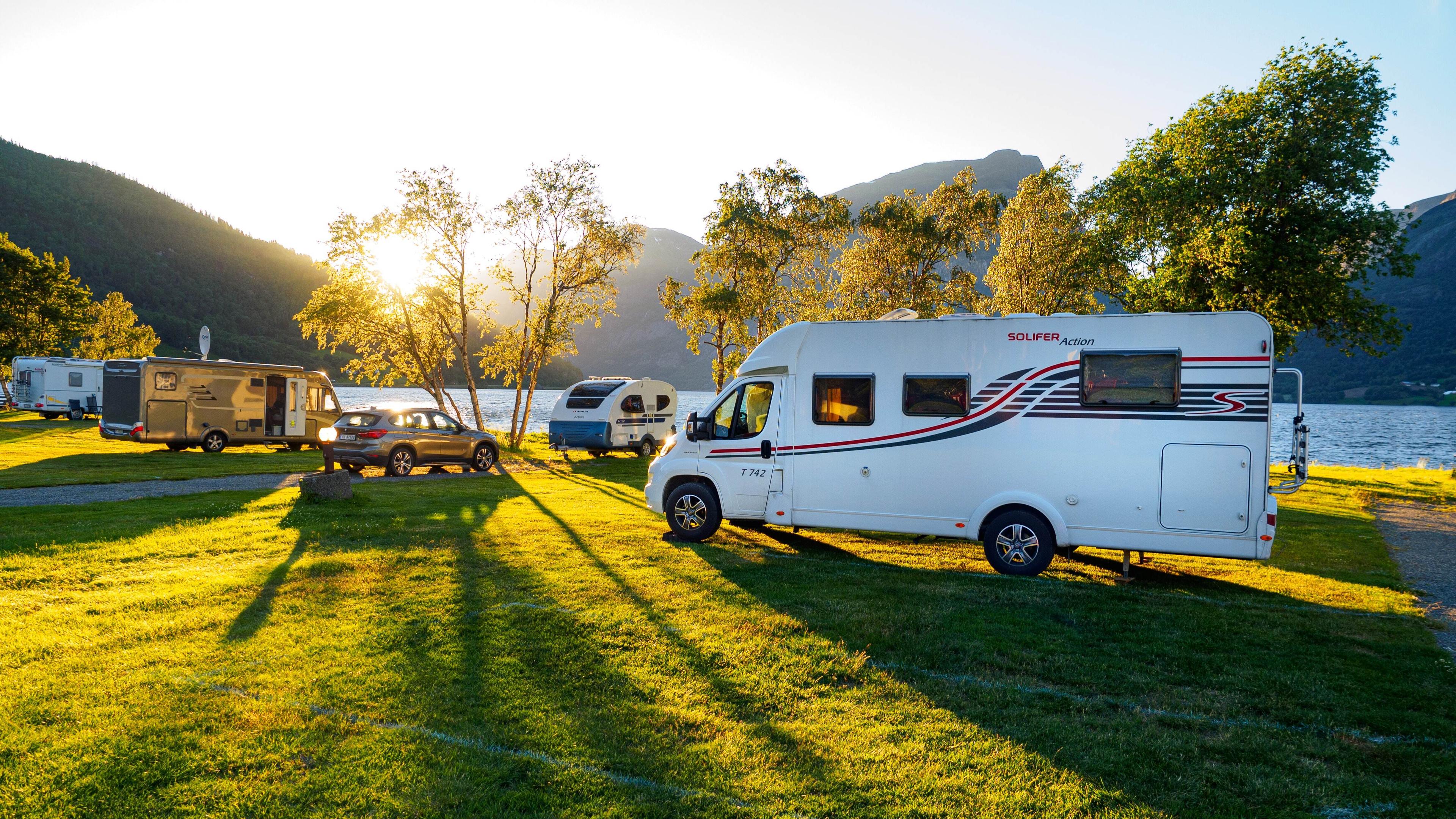 Class C motorhome with high resale value parked at scenic mountain overlook during golden hour sunset, representing best RV investment choices