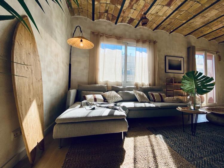 living room with couch and surf board in beach style fashion
