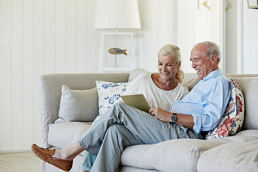 An elder couple sitting on their couch