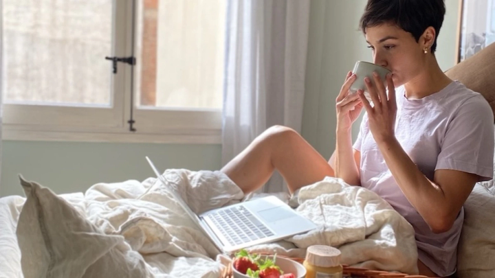 woman in bed on computer