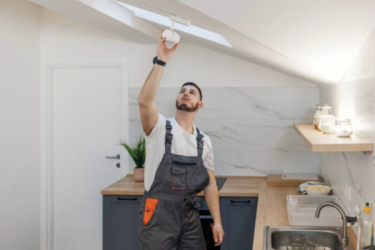 A guy performing maintenance in the house