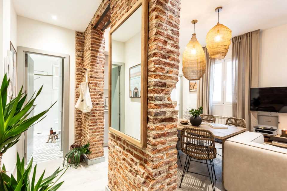 1653901145-brick-wall-entrance-and-living-room.jpg