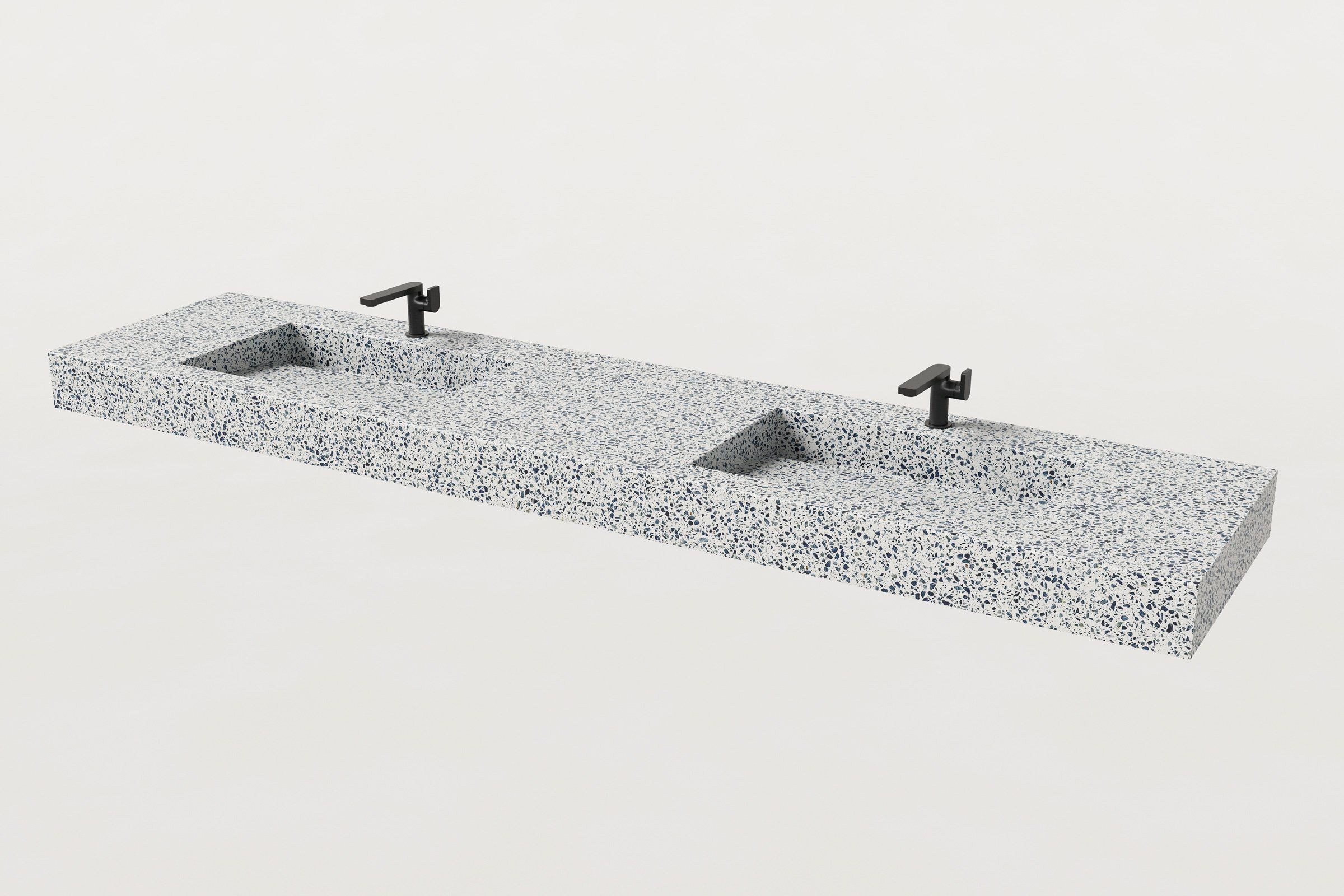 Terrazzo double-basin sink with two matte black faucets installed.