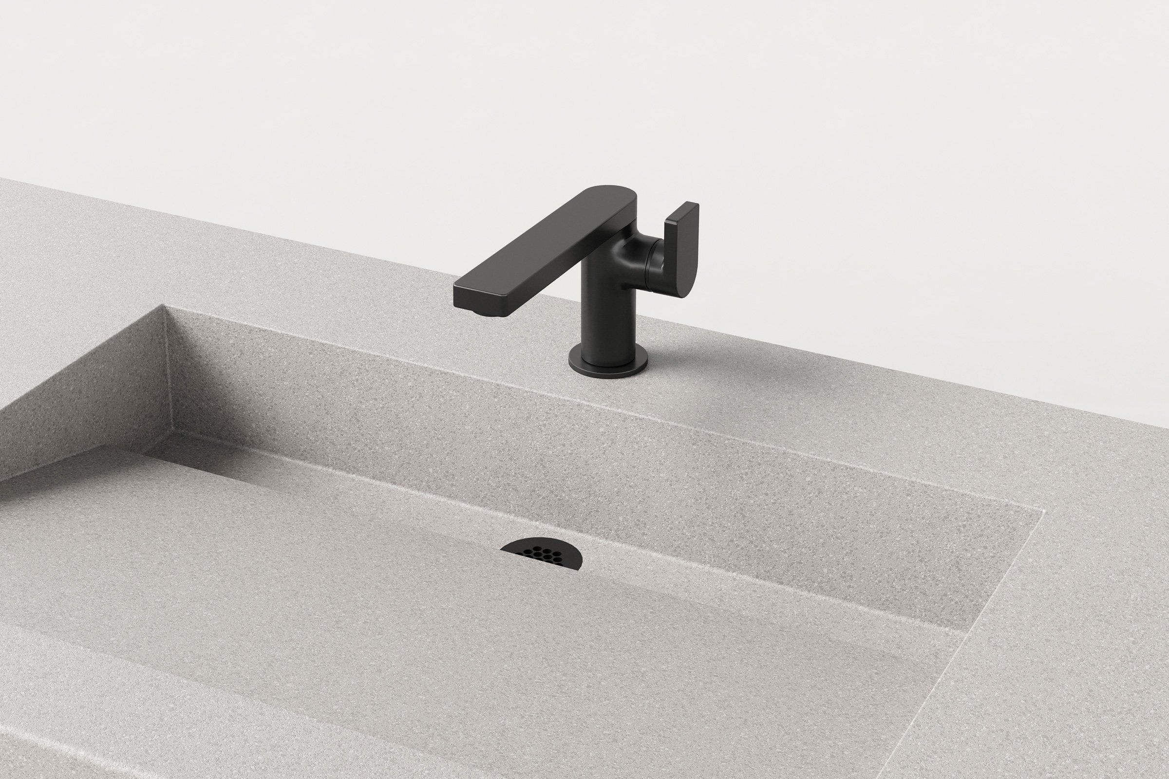 Close-up of Manos Trof Flow 48-inch Fog concrete sink with black faucet and linear drain.