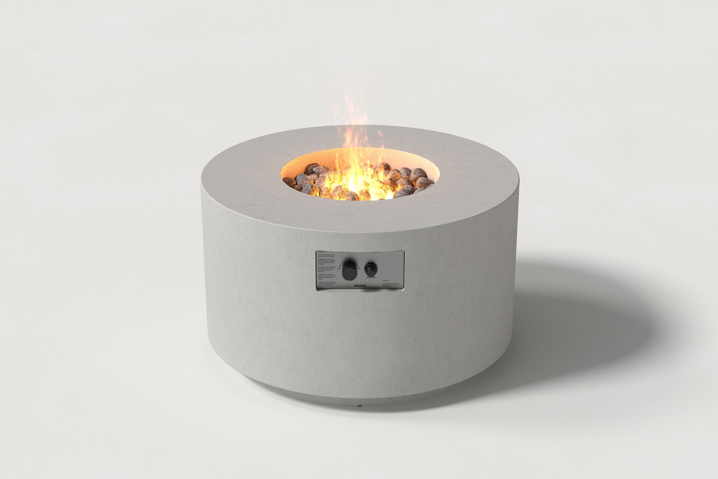 Low cylindrical light grey colored concrete fire pit with thick walls and a central circular well filled with dark volcanic rocks and flame. Side view on a white background.