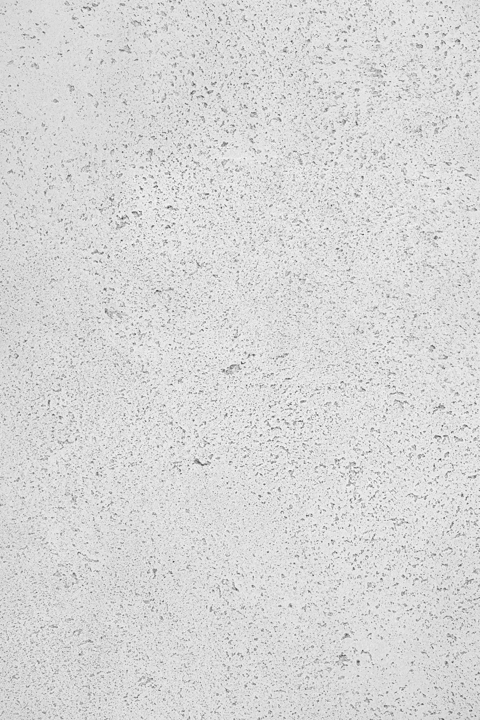 Close up of white concrete swatch sample. Flat surface with a subtle textured finish.
