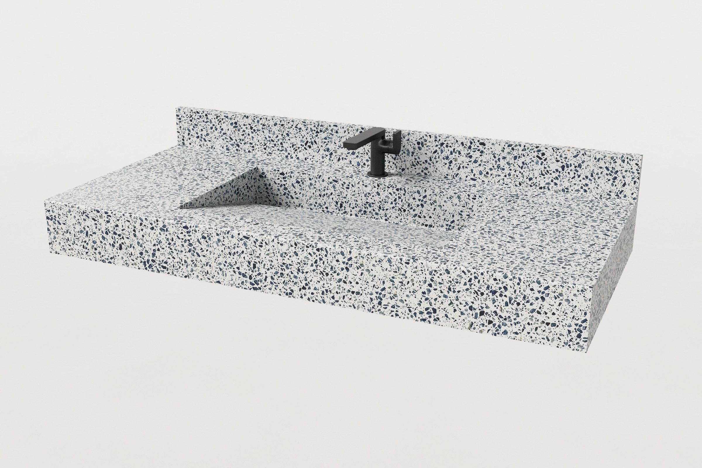 Rectangular terrazzo sink basin in Unazzo finish with a matching backsplash and matte black faucet.