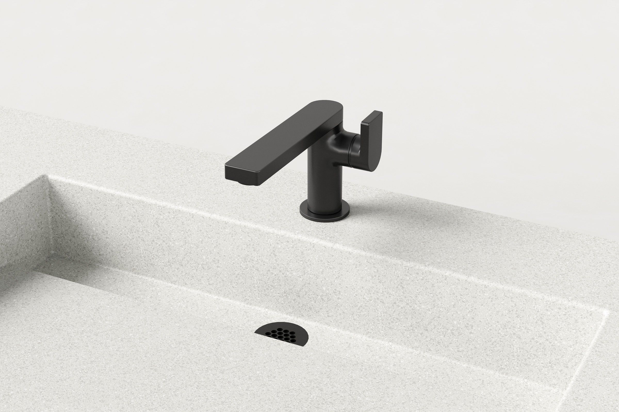 Close-up of a matte black faucet mounted over one basin of a white concrete double sink, showing the drain detail.