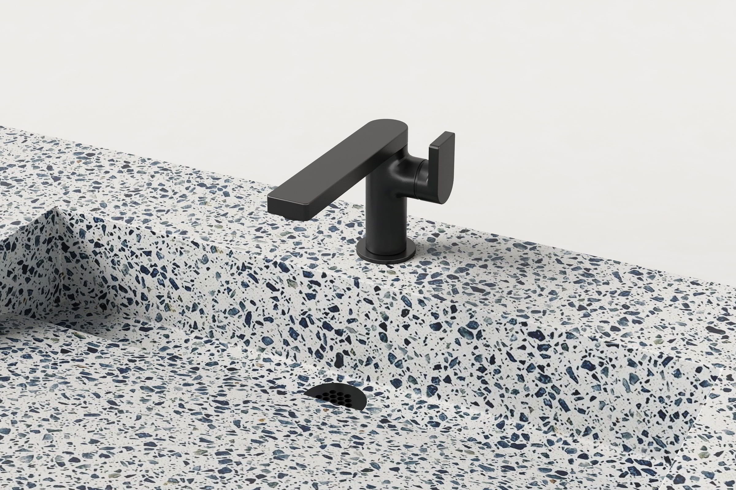 Close-up of black faucet and drain detail on Unazzo Trof sink.