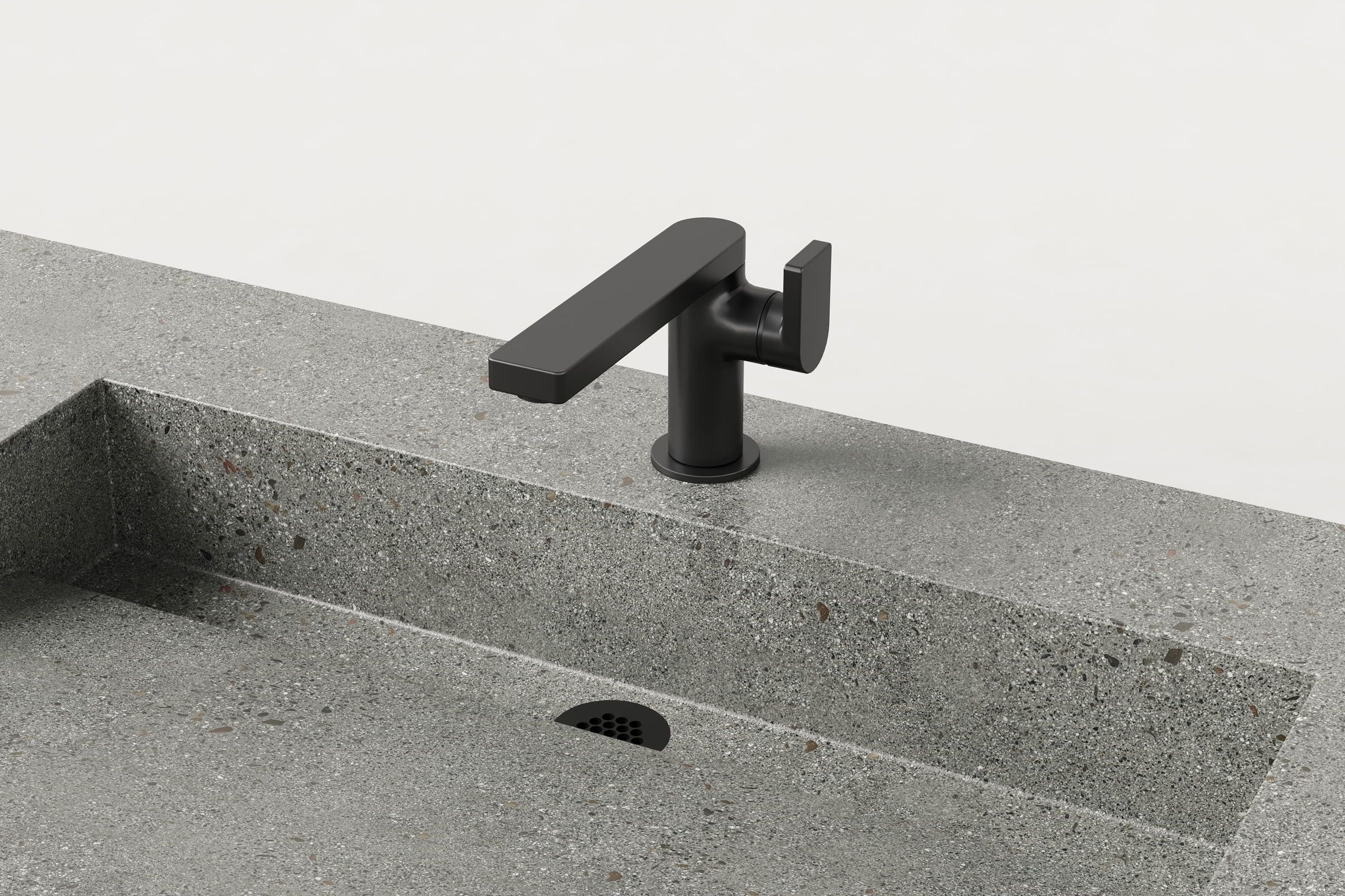 Close-up of black faucet and drain detail on Juda Trof sink.