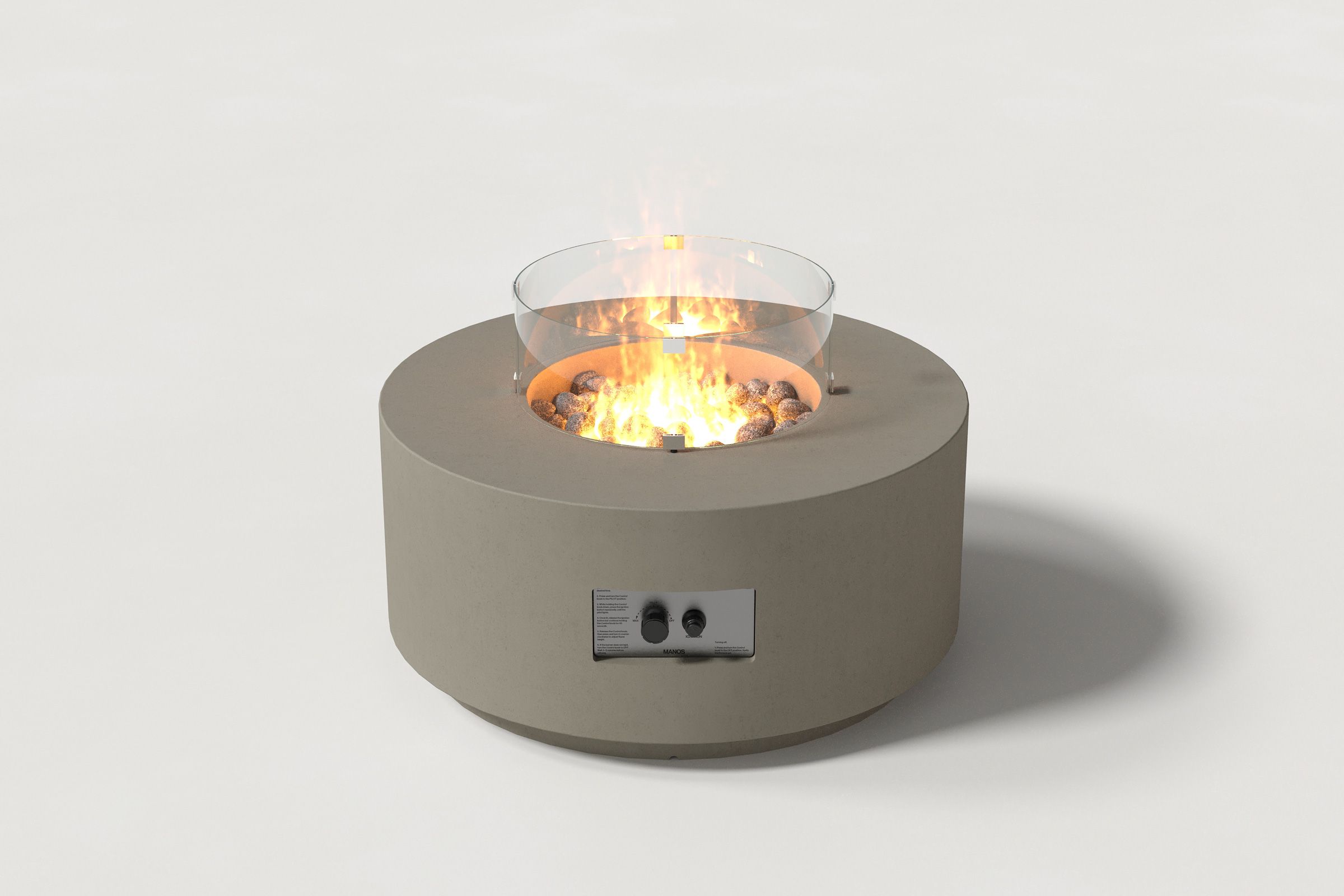 Low cylindrical dark grey colored concrete fire pit with thick walls and a central circular well filled with dark volcanic rocks and flame, featuring an integrated control panel and glass shield. Front view on a white background.