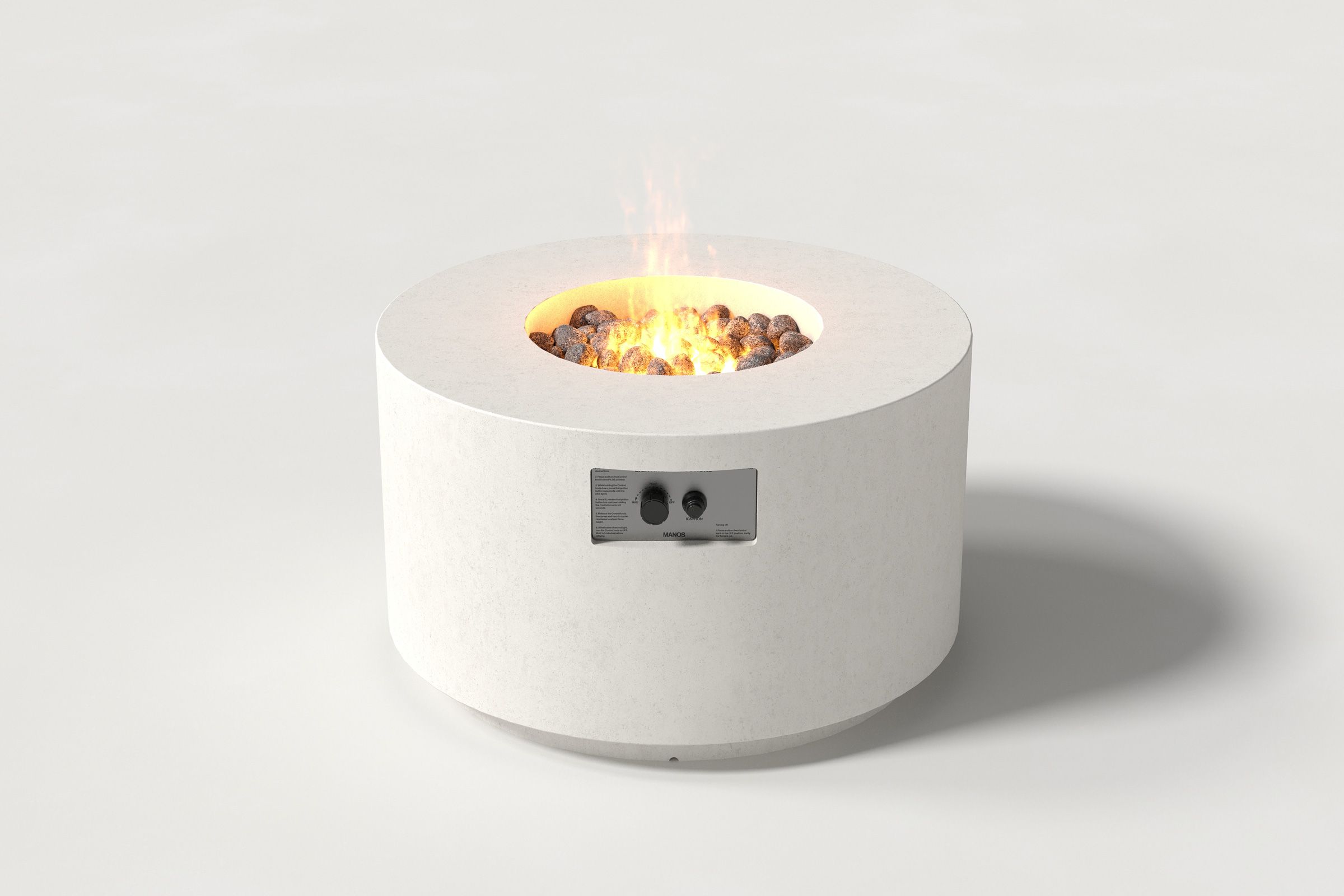 Low cylindrical white colored concrete fire pit with thick walls and a central circular well filled with dark volcanic rocks and flame. Side view on a white background.