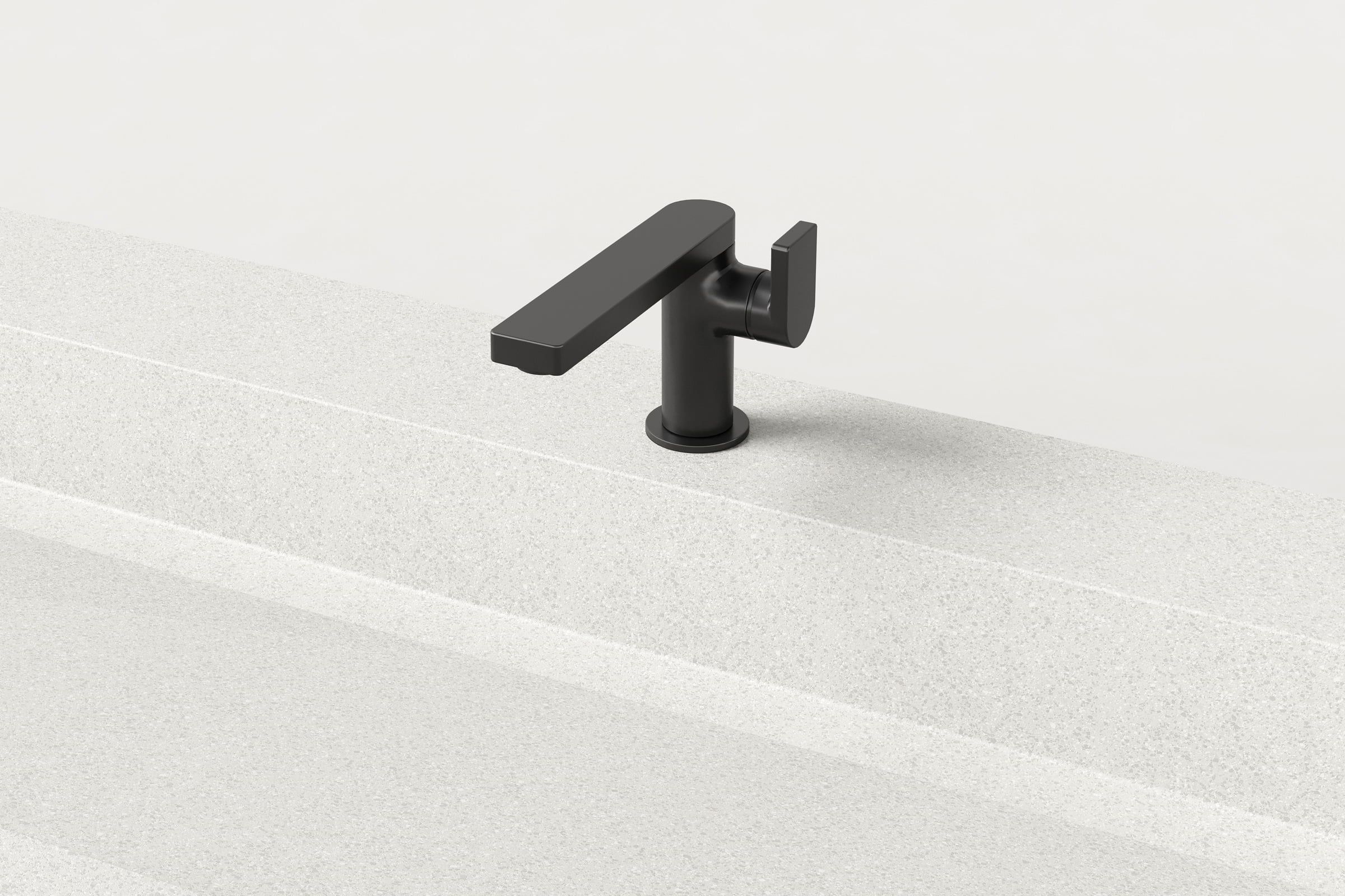 Close-up of matte black faucet on white Trof sink.
