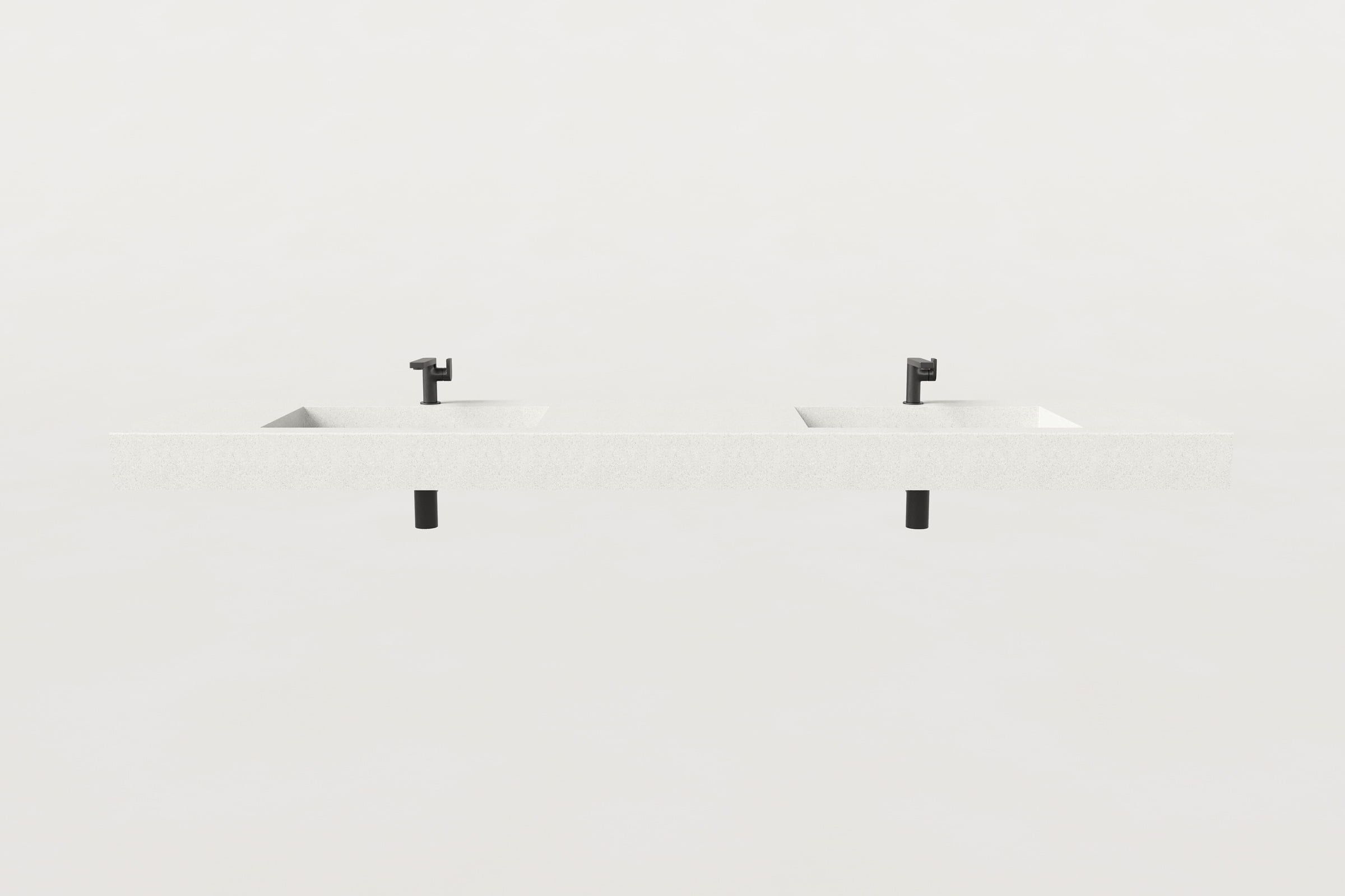 Front view of white double-basin Trof sink with two drains.