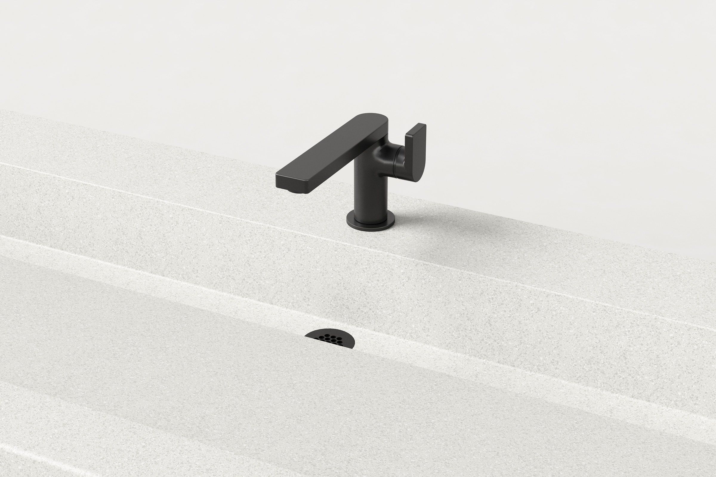 A close-up of the matte black faucet on the Chalk concrete sink, with the integrated slot drain visible below.