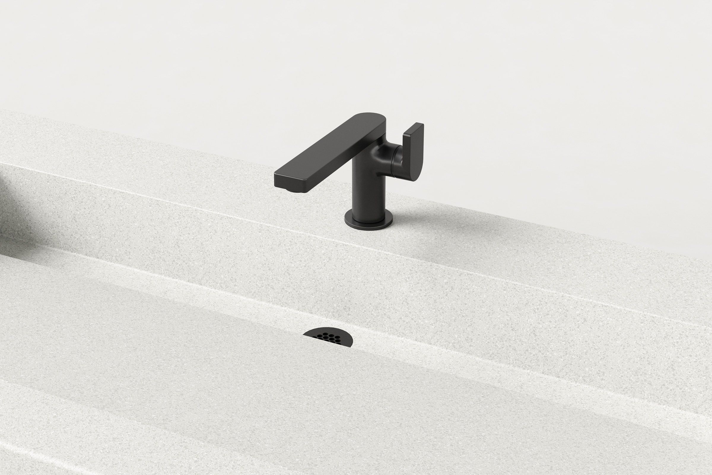 Close-up of the Chalk concrete sink basin showing the matte black faucet and slotted drain detail.