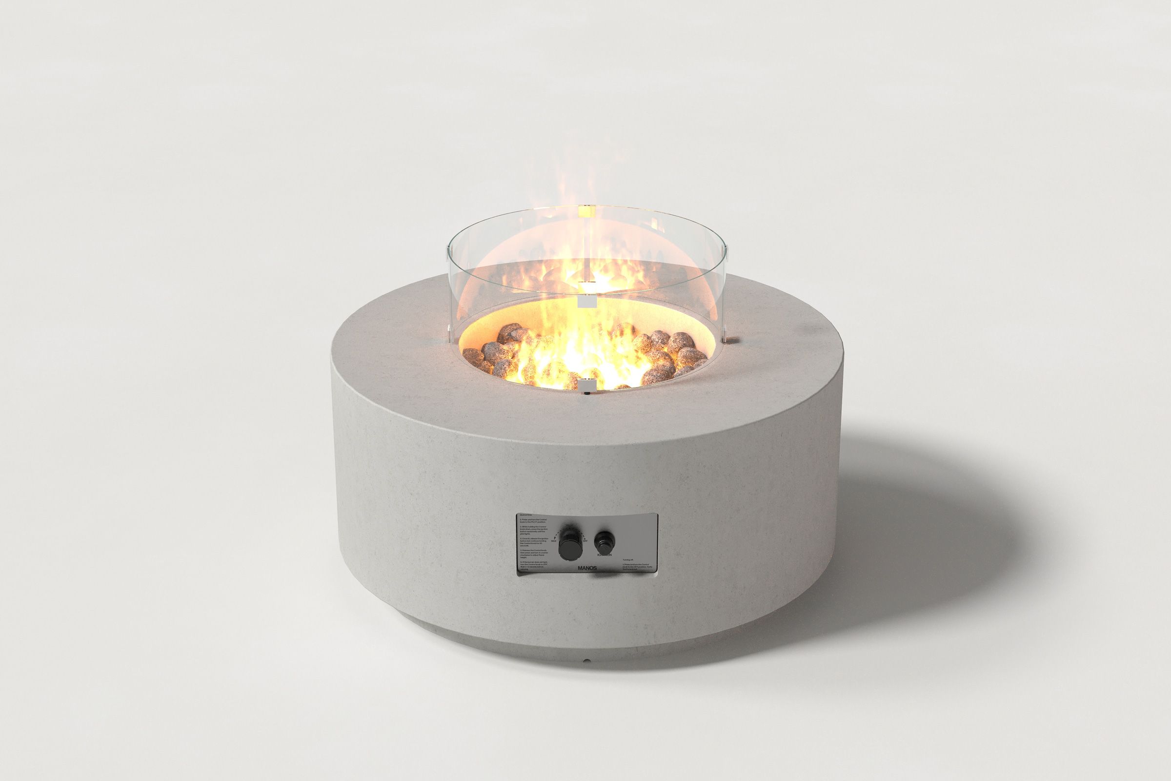 Low cylindrical grey colored concrete fire pit with thick walls and a central circular well filled with dark volcanic rocks and flame, featuring an integrated control panel and glass shield. Front view on a white background.