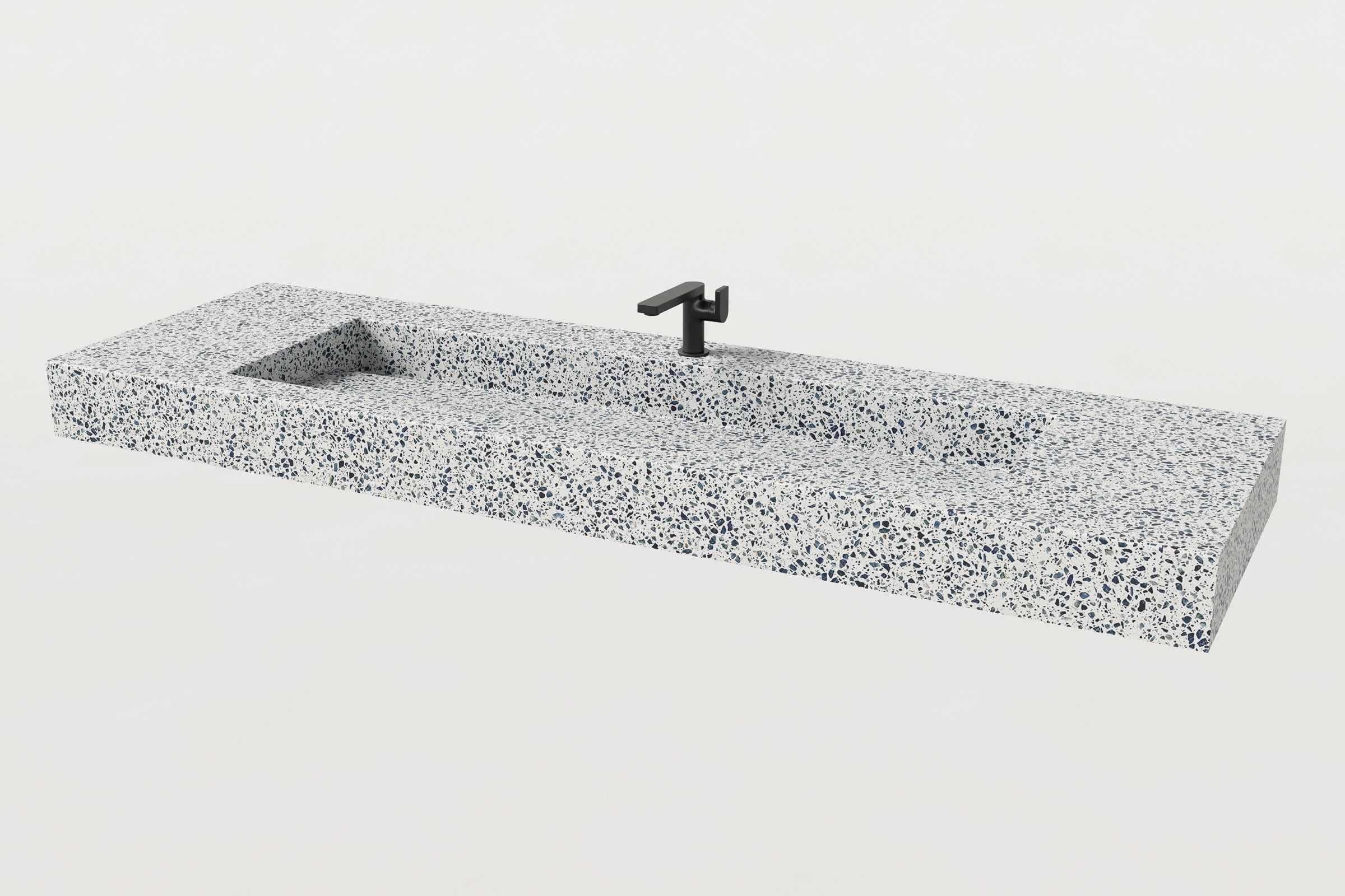 Terrazzo trough sink in white with navy and gray aggregate, with single matte black faucet at center.