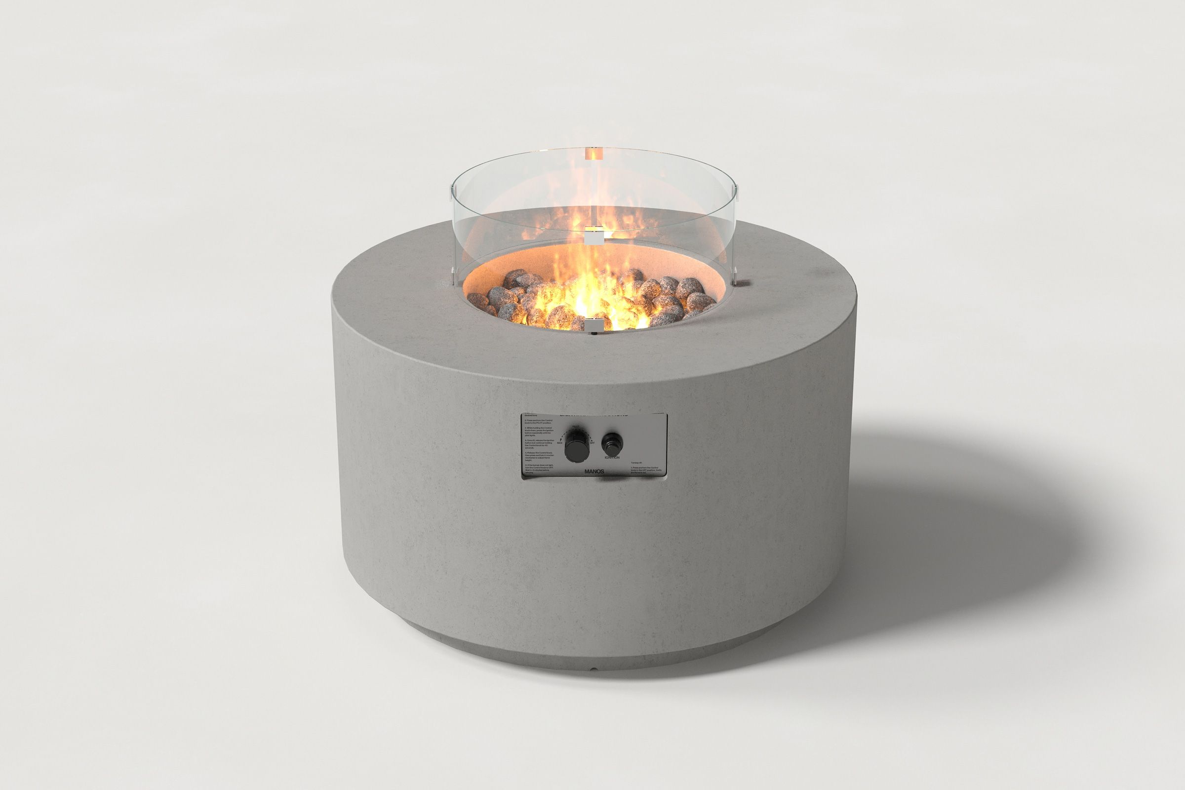 Low cylindrical grey colored concrete fire pit with thick walls and a central circular well filled with dark volcanic rocks and flame, featuring an integrated control panel and glass shield. Front view on a white background.