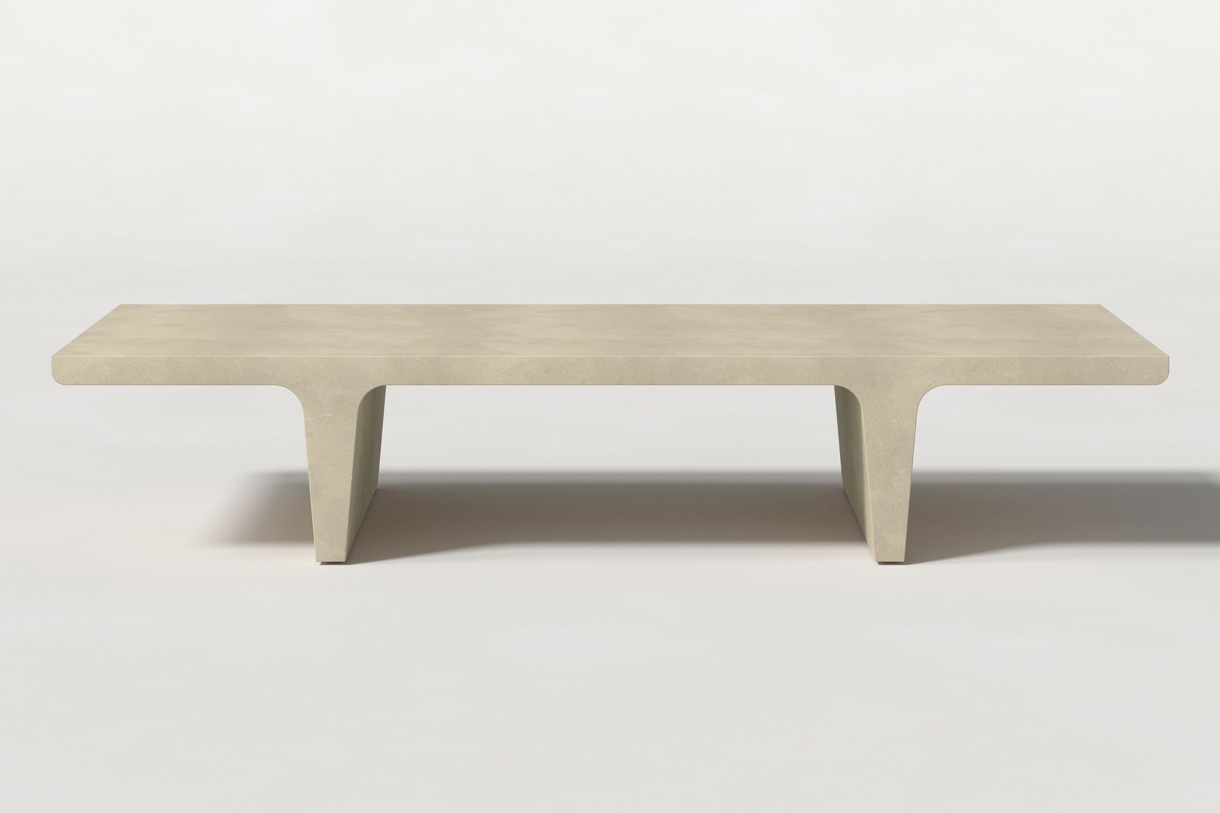 Rectangular solid light beige concrete coffee table with sculptural double tee legs and a smooth top, set against a clean white background.