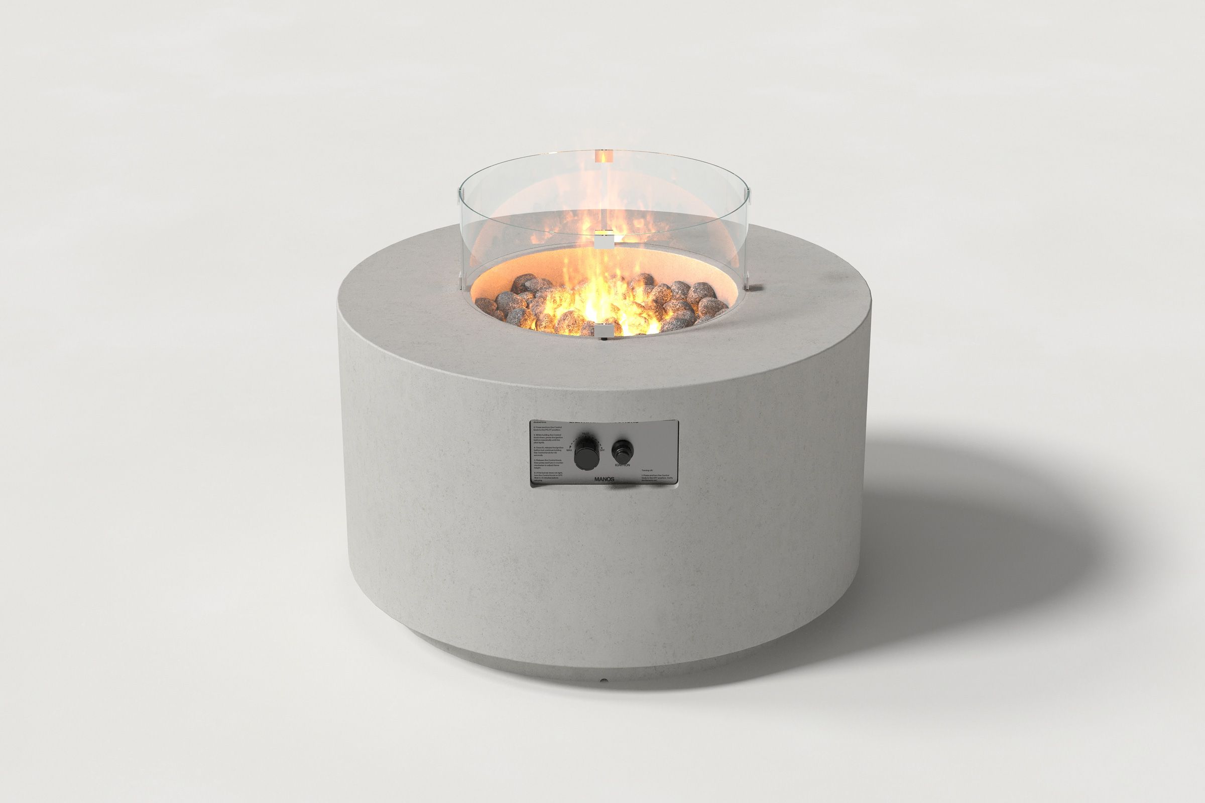 Low cylindrical light grey colored concrete fire pit with thick walls and a central circular well filled with dark volcanic rocks and flame, featuring an integrated control panel and glass shield. Front view on a white background.