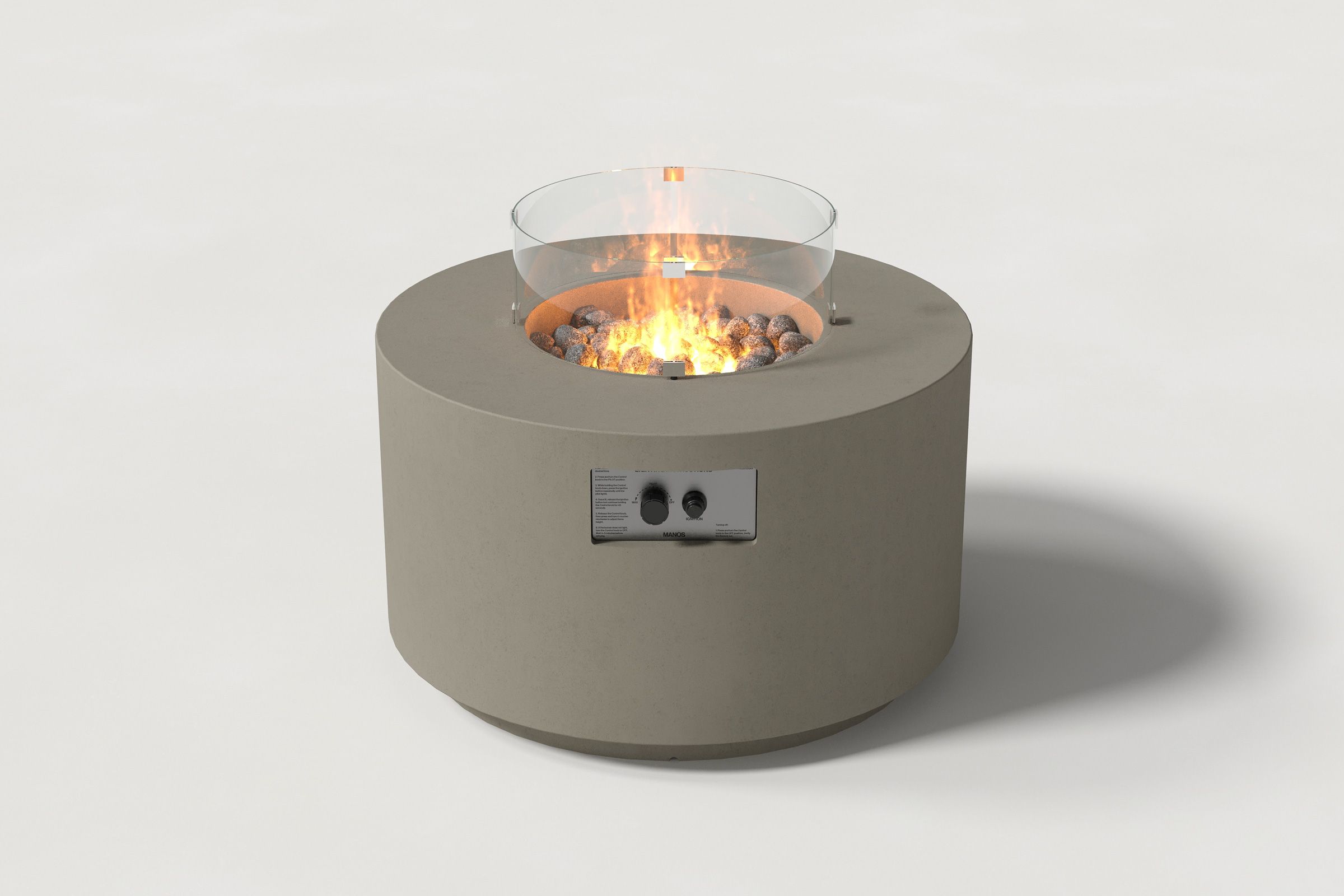 Low cylindrical dark grey colored concrete fire pit with thick walls and a central circular well filled with dark volcanic rocks and flame, featuring an integrated control panel and glass shield. Front view on a white background.