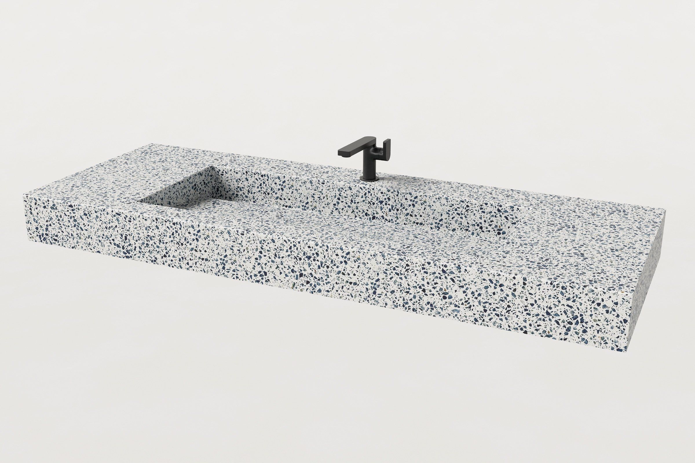 Trof Drop 60 sink in Unazzo terrazzo finish, ¾ angled view with matte black single-hole faucet installed.