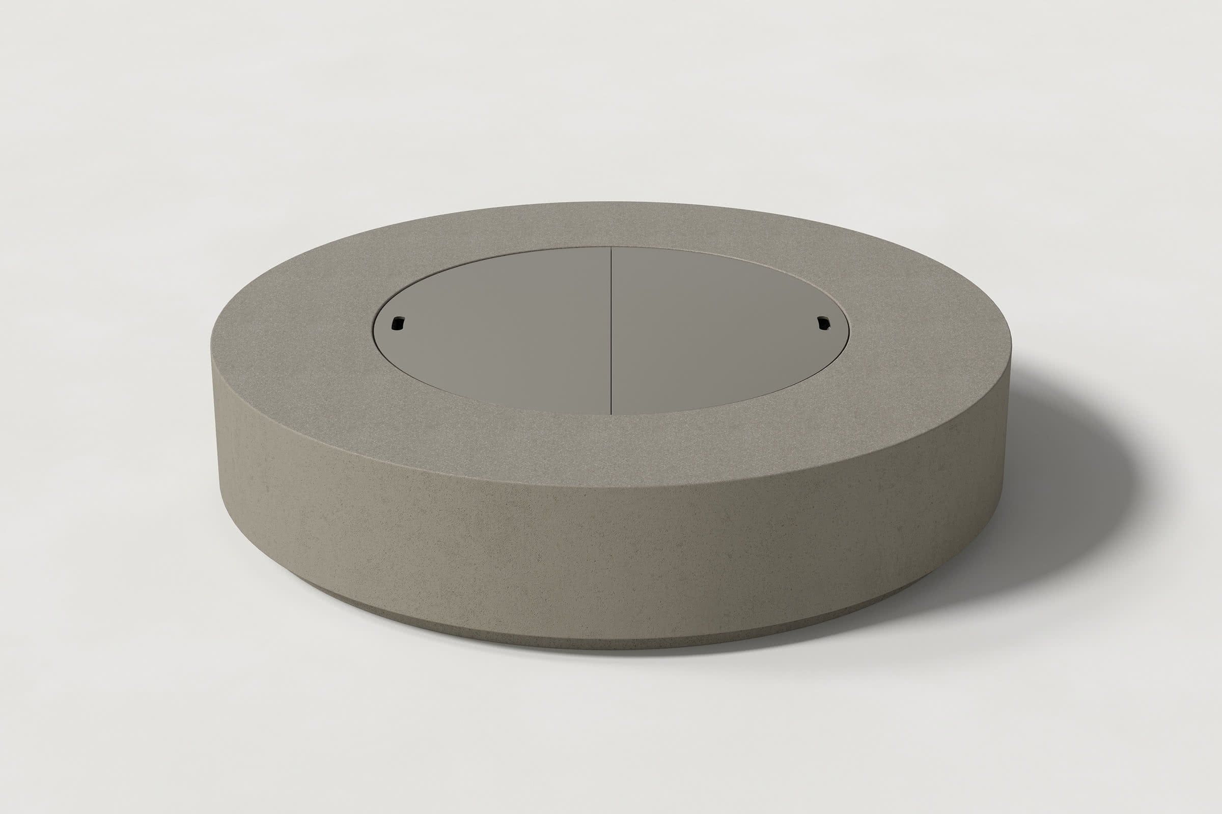 Low cylindrical dark grey concrete fire pit with thick walls and a central circular well. Mid-range angle shows the well covered with matching cover with handles against a white background.