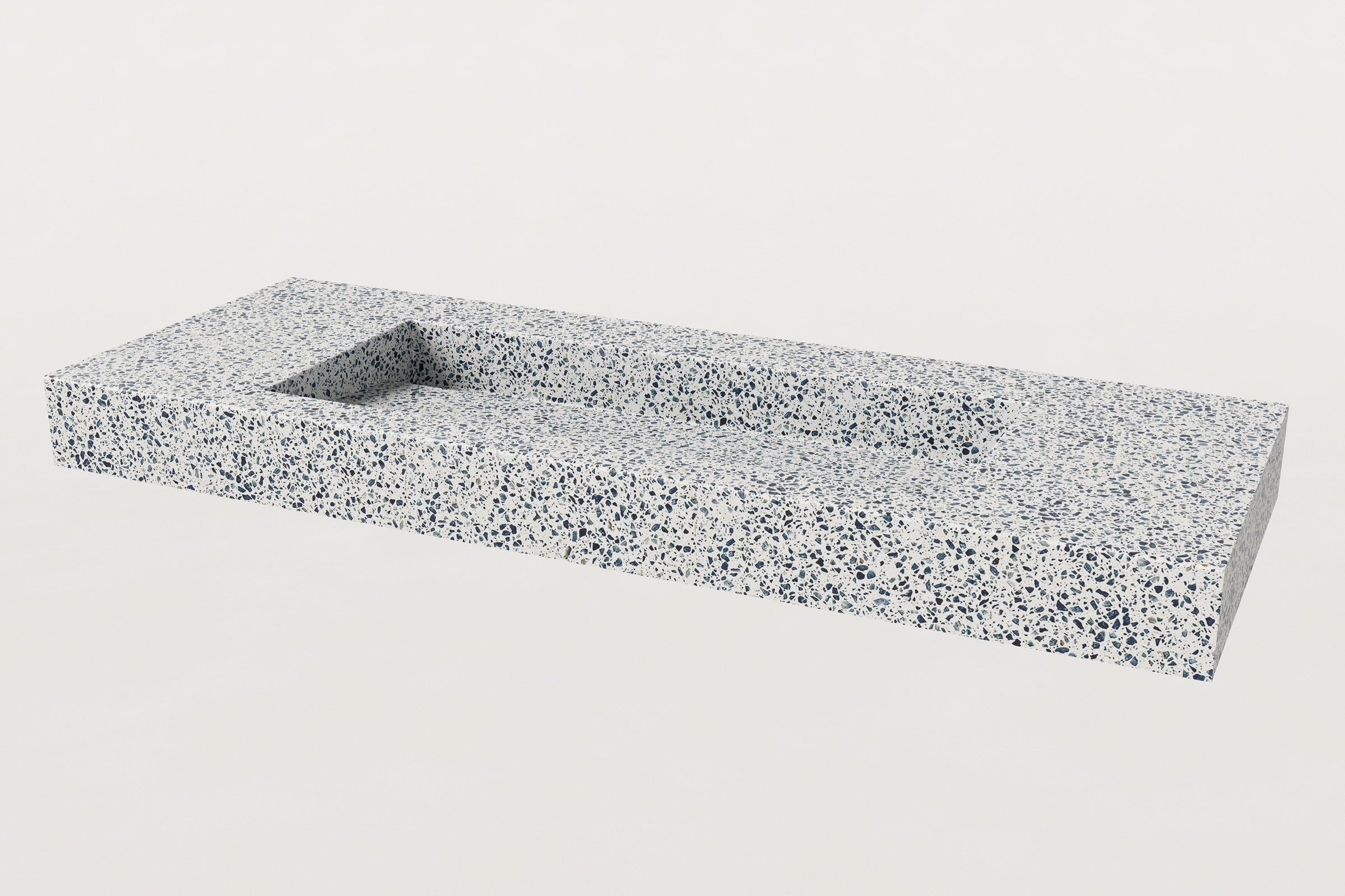 Trof Drop 60 sink in Unazzo terrazzo finish, ¾ angled view, no faucet, showing the rectangular basin and integrated slope.