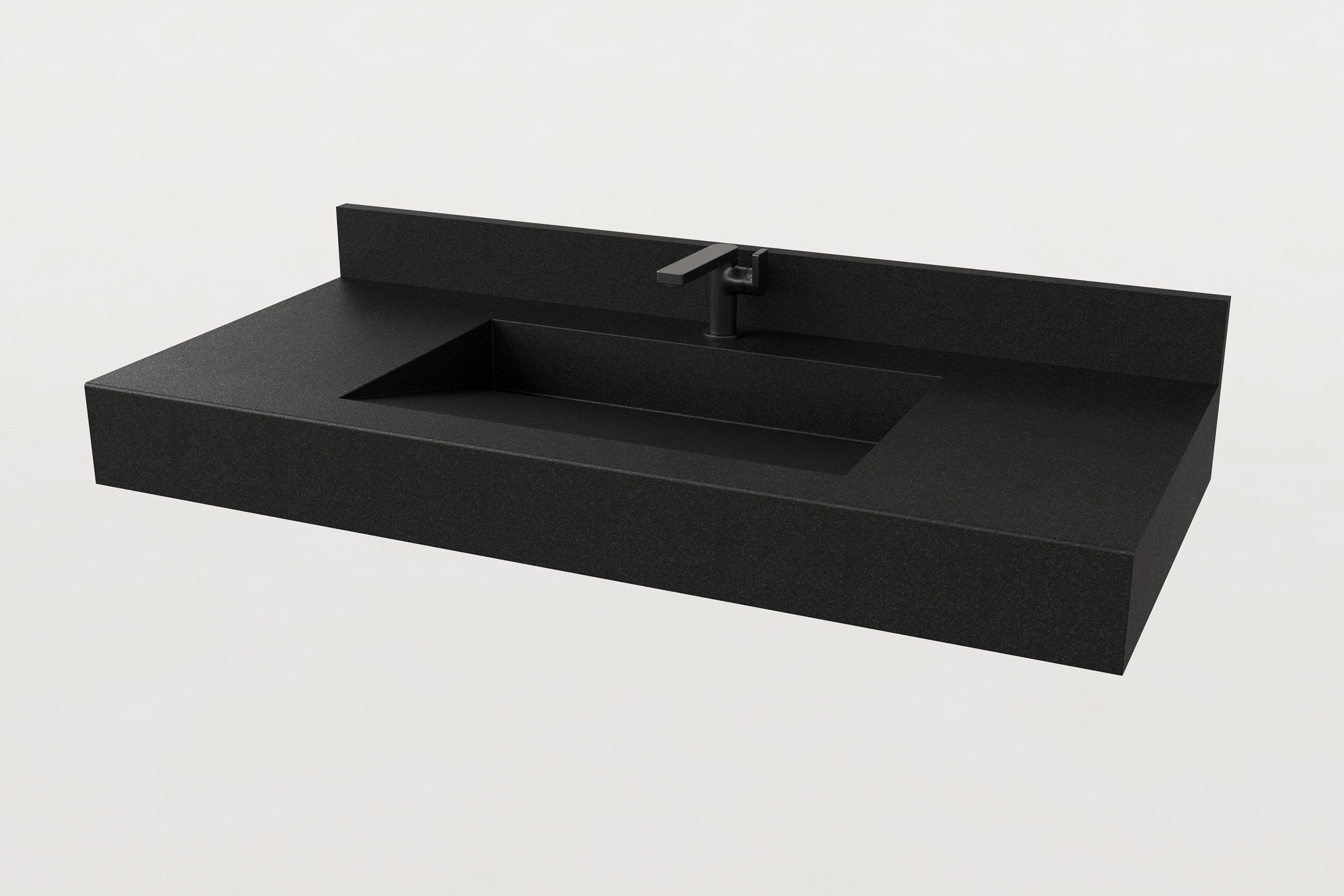 Rectangular concrete sink basin in Storm finish with a matching backsplash and matte black faucet.