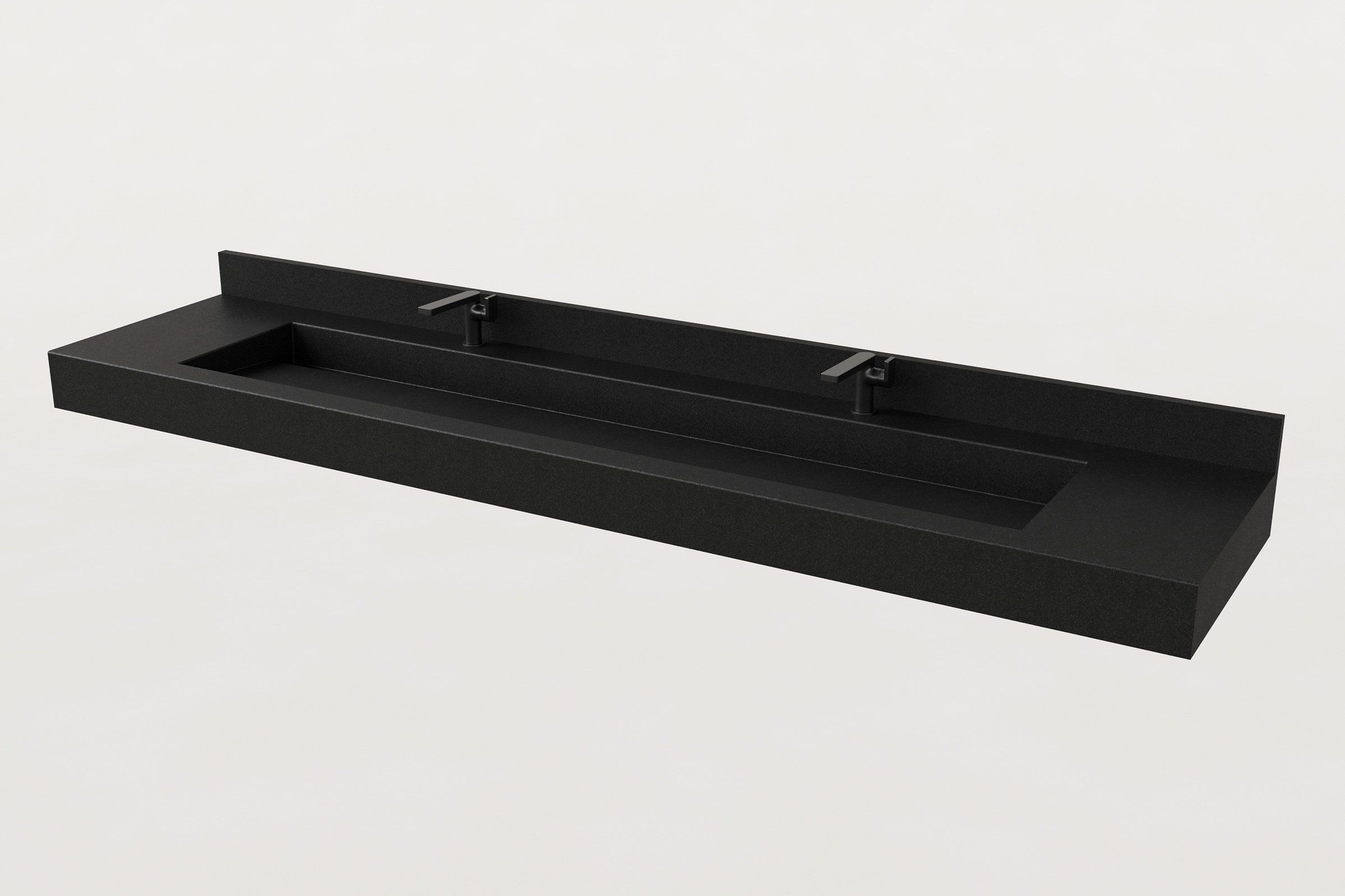 Angled view of a long black concrete sink with integrated backsplash and two matte black faucets.