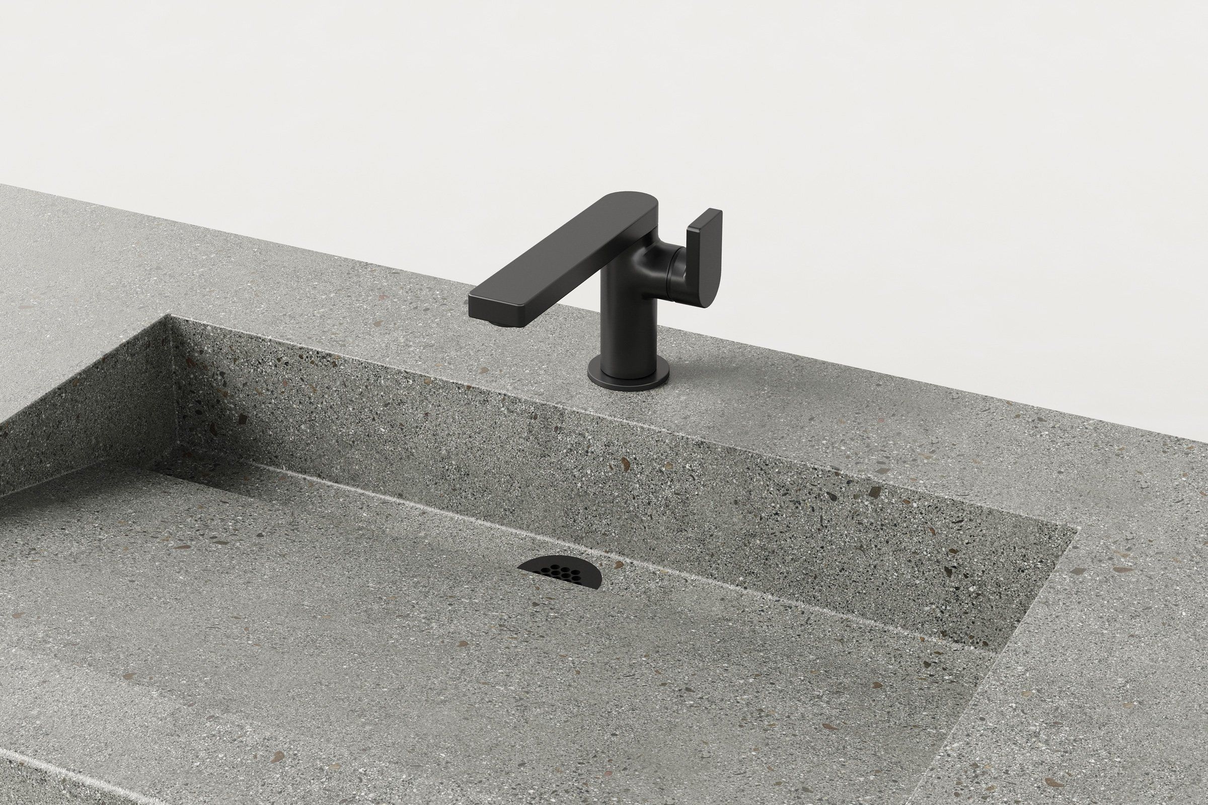Close-up of Juda finish basin with matte black faucet and discreet slot drain.