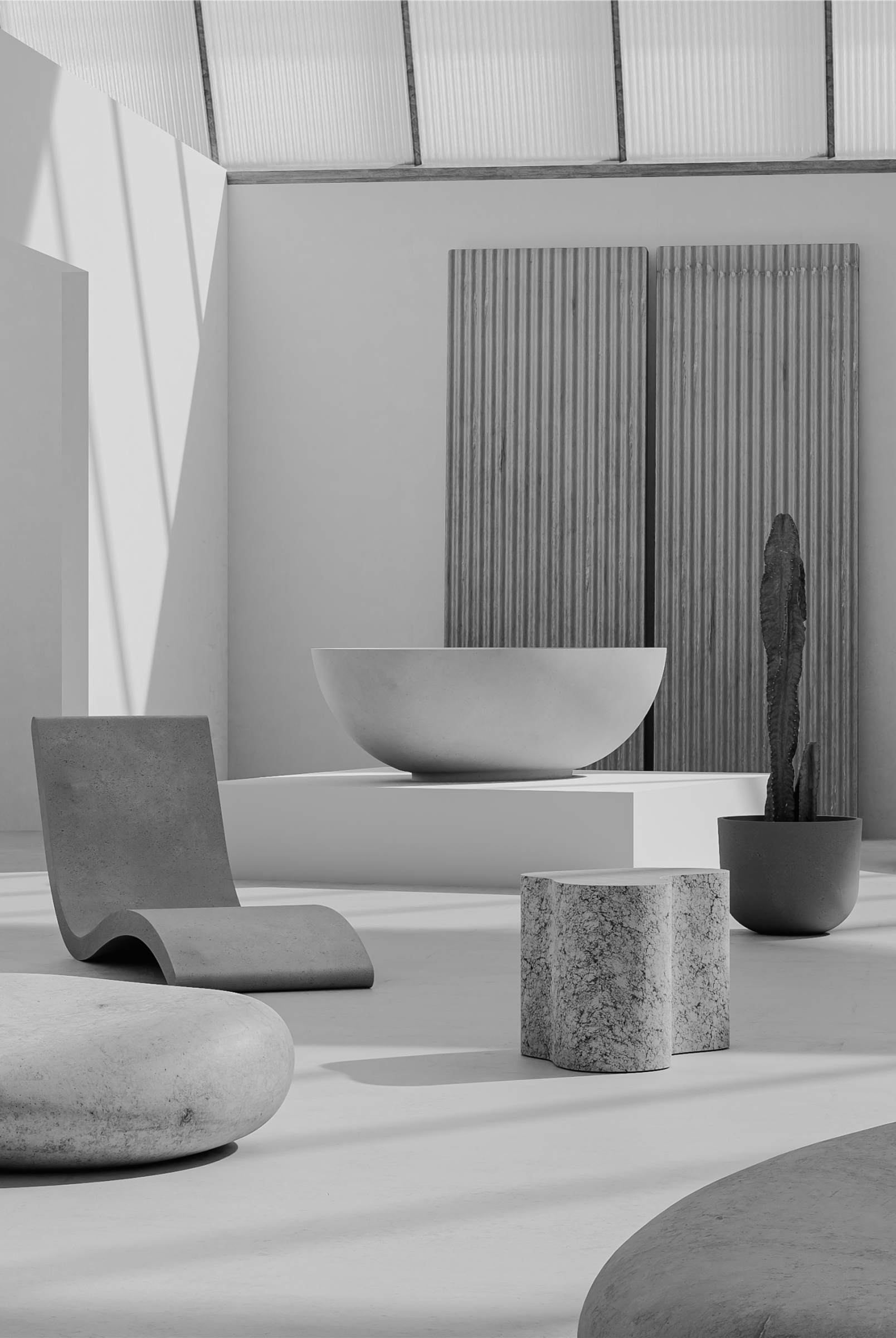 Greyscale photo of a minimalist interior with concrete lounge chair, white basin, stone side table, and cactus against ribbed metal panels with a translucent ceiling