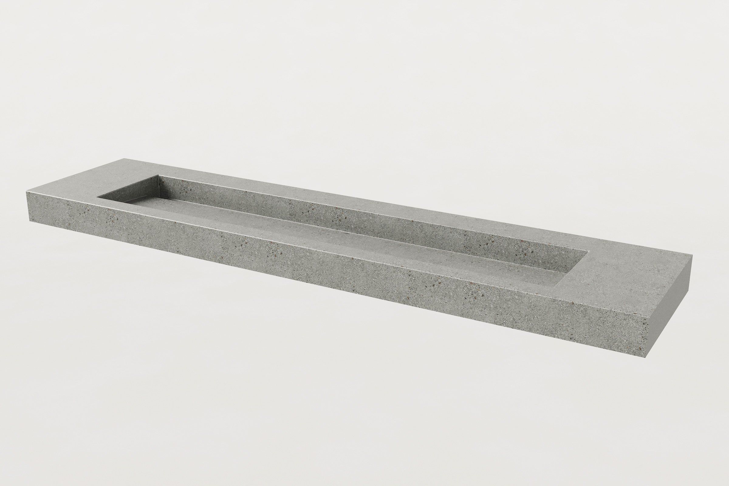 Concrete trough sink with a single long rectangular basin, no faucets installed.