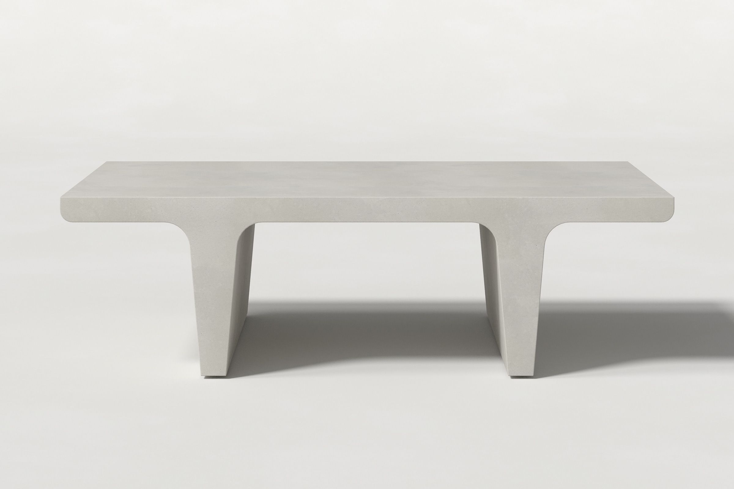 Rectangular solid light grey concrete coffee table with sculptural double tee legs and a smooth top, set against a clean white background.
