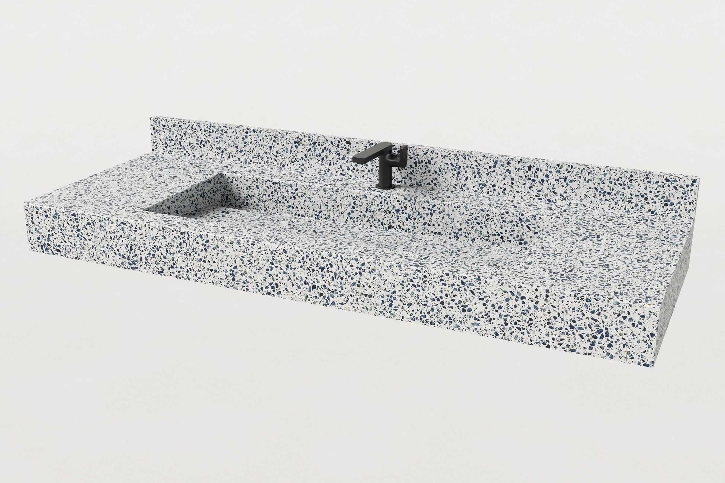 Trof Drop 60 sink in Unazzo terrazzo finish, ¾ angled view with matte black faucet and matching Unazzo backsplash.