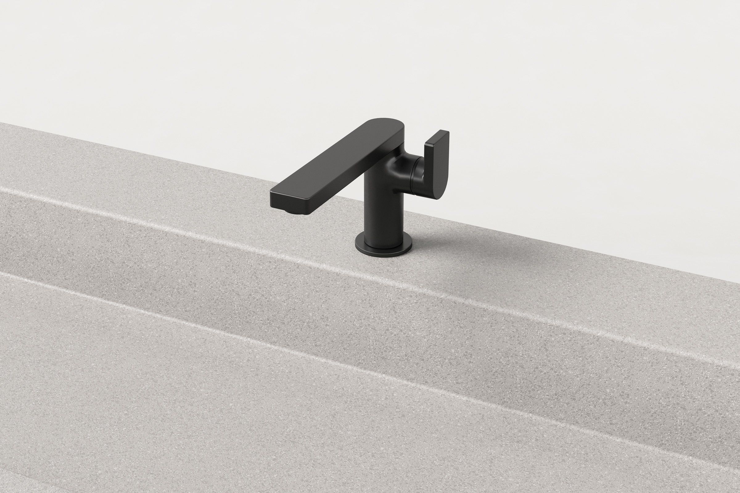 Close-up of matte black faucet installed on fog finish concrete trough sink.