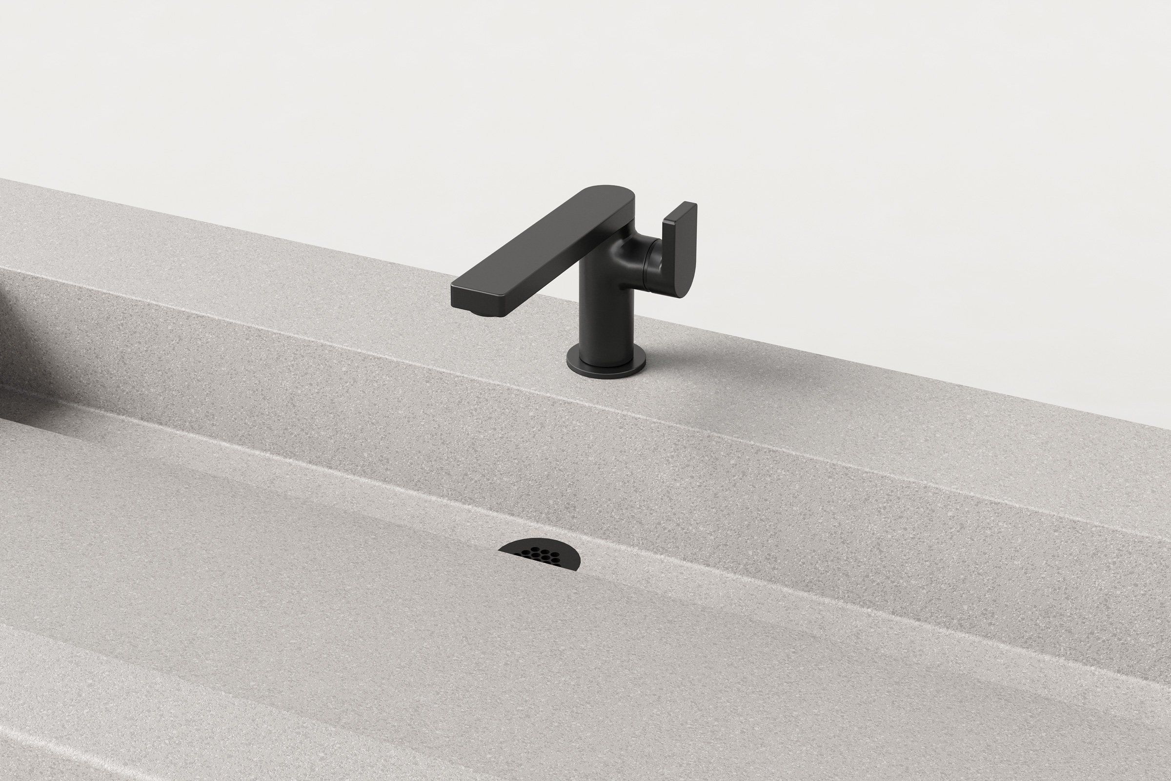 Close-up of the Fog concrete sink basin showing the matte black faucet and slotted drain detail.