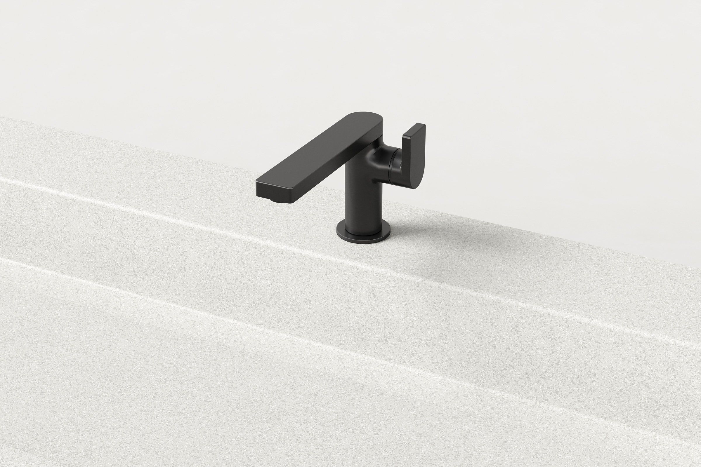 Close-up of a single matte black faucet mounted on a white concrete sink with a rectangular basin.