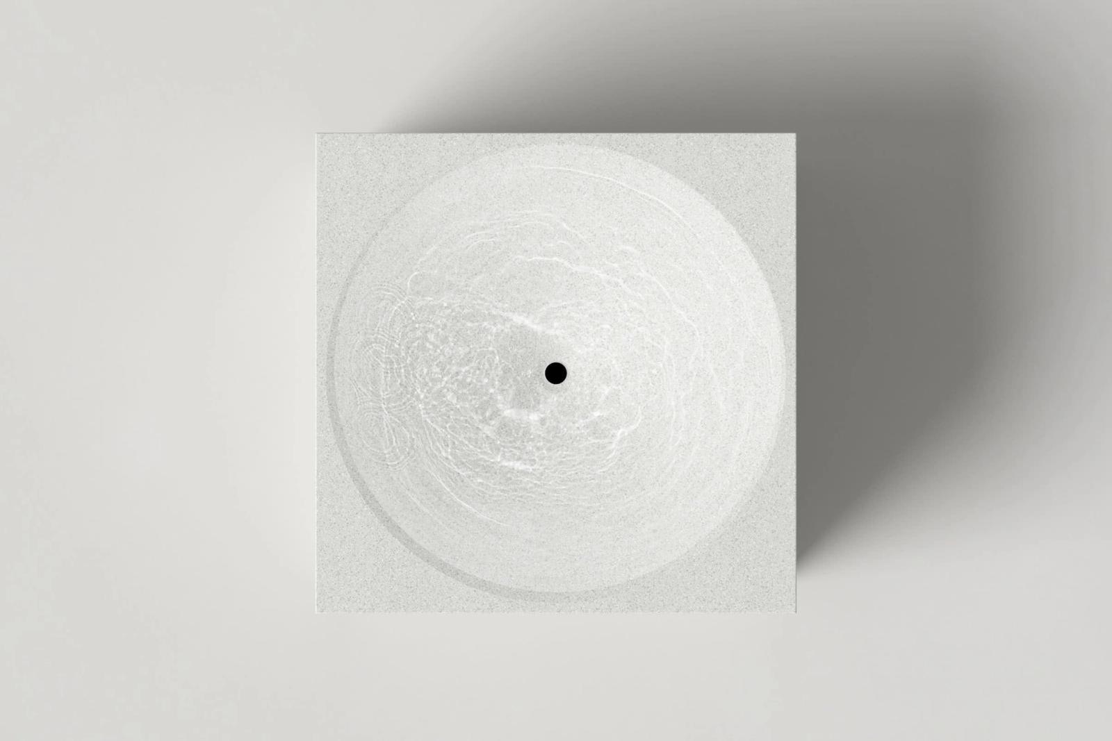 Top-down view of a textured white concrete cube basin, with circular concave sink filled with rippling water and central black drain. Angular design against a white background.