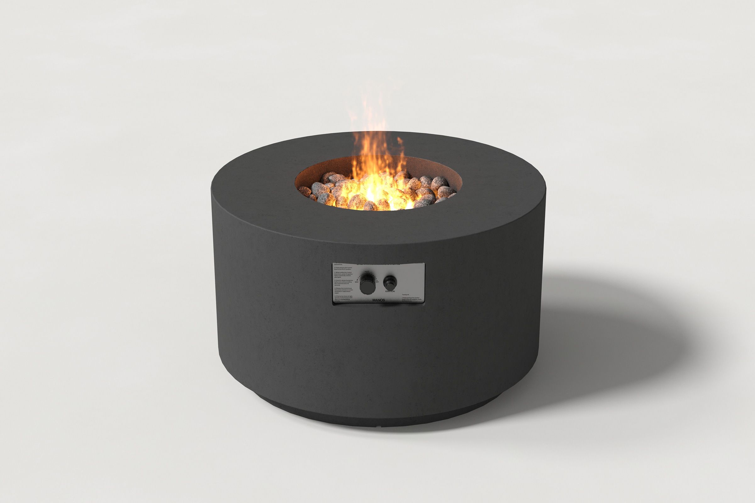 Low cylindrical charcoal colored concrete fire pit with thick walls and a central circular well filled with dark volcanic rocks and flame. Side view on a white background.