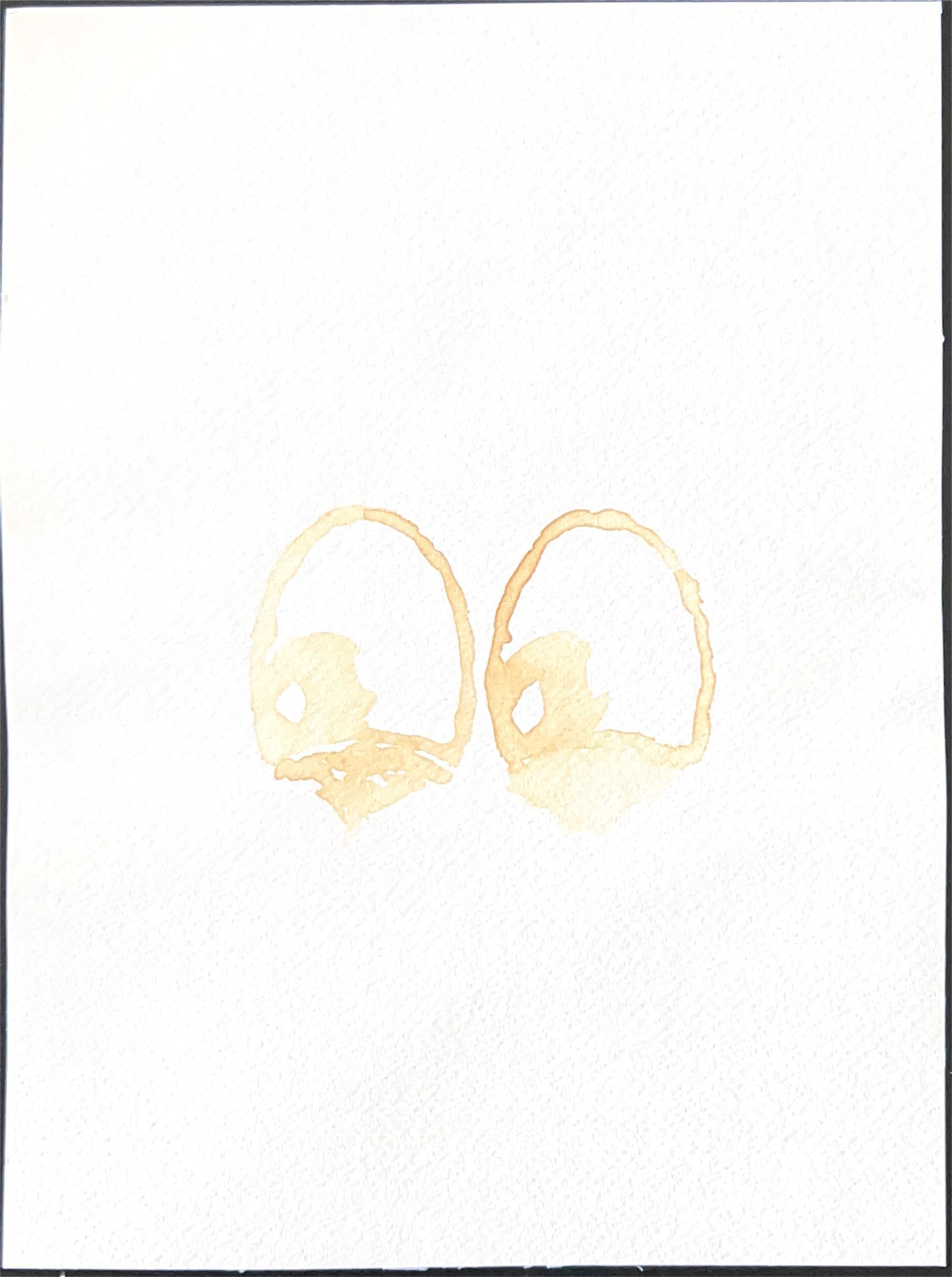 Drawing of two oval eyes in pale lemon juice on white paper