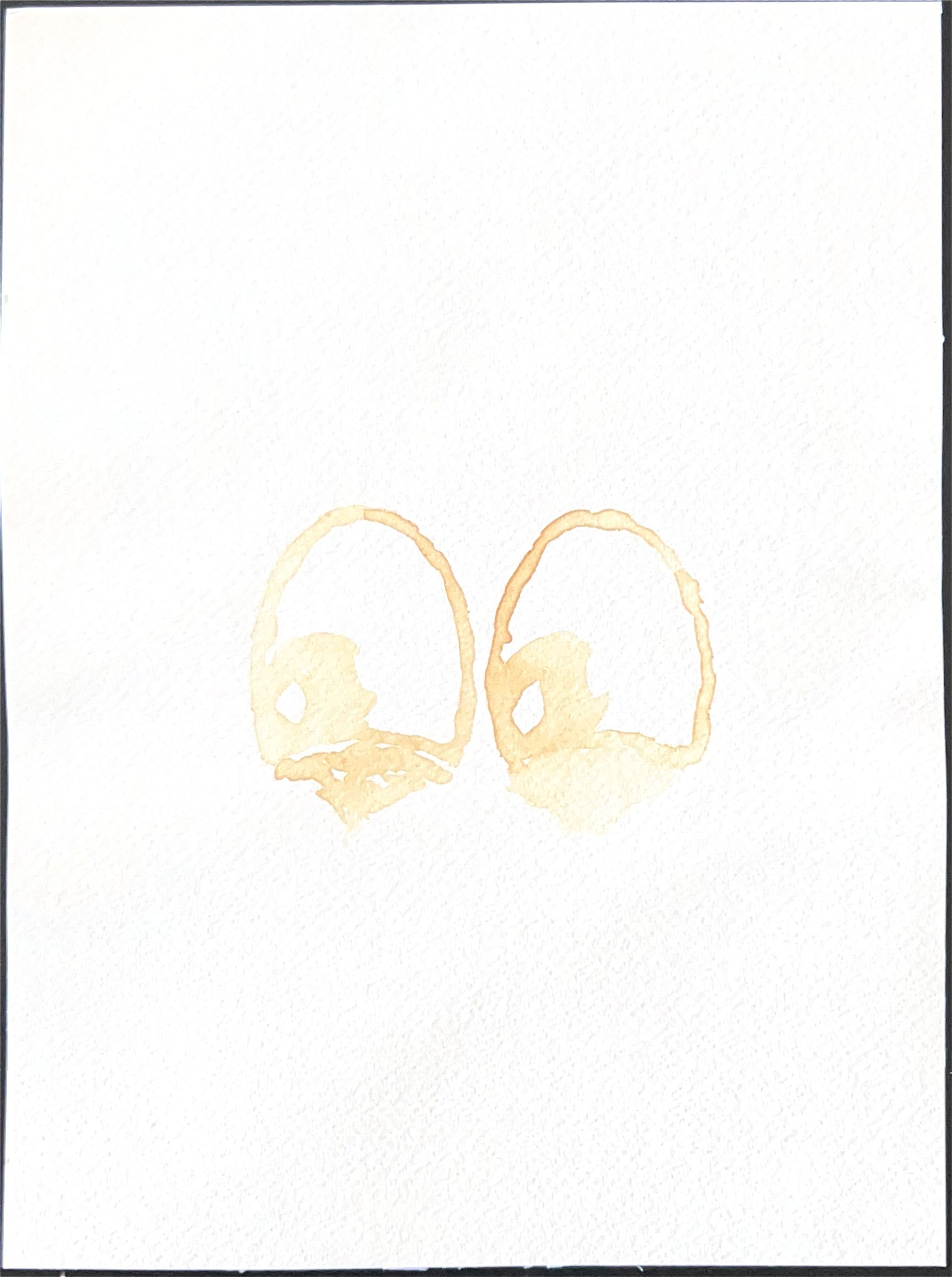 Drawing of two oval eyes in pale lemon juice on white paper