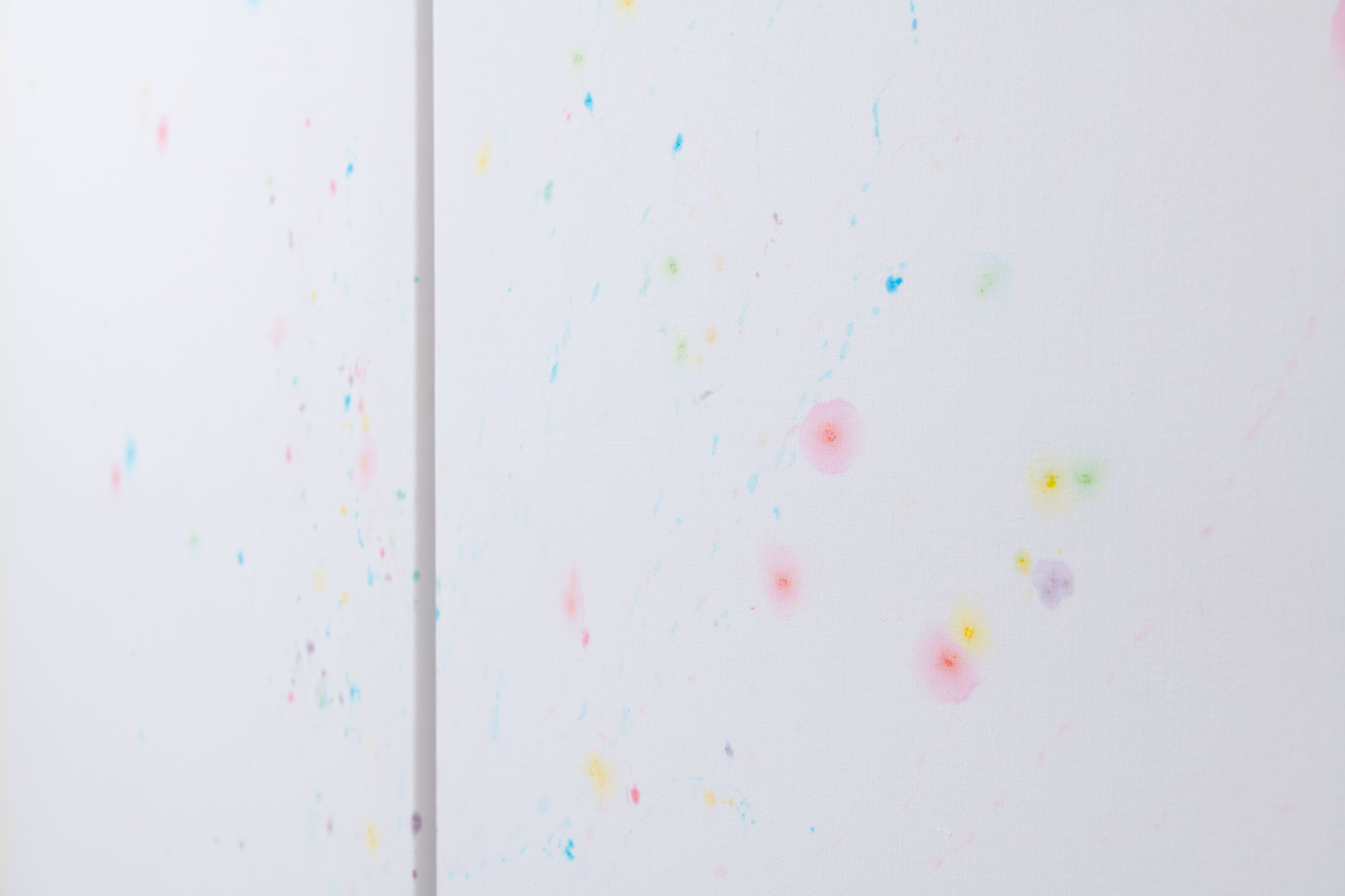 Detail of coloured m&m's stains on white sheets