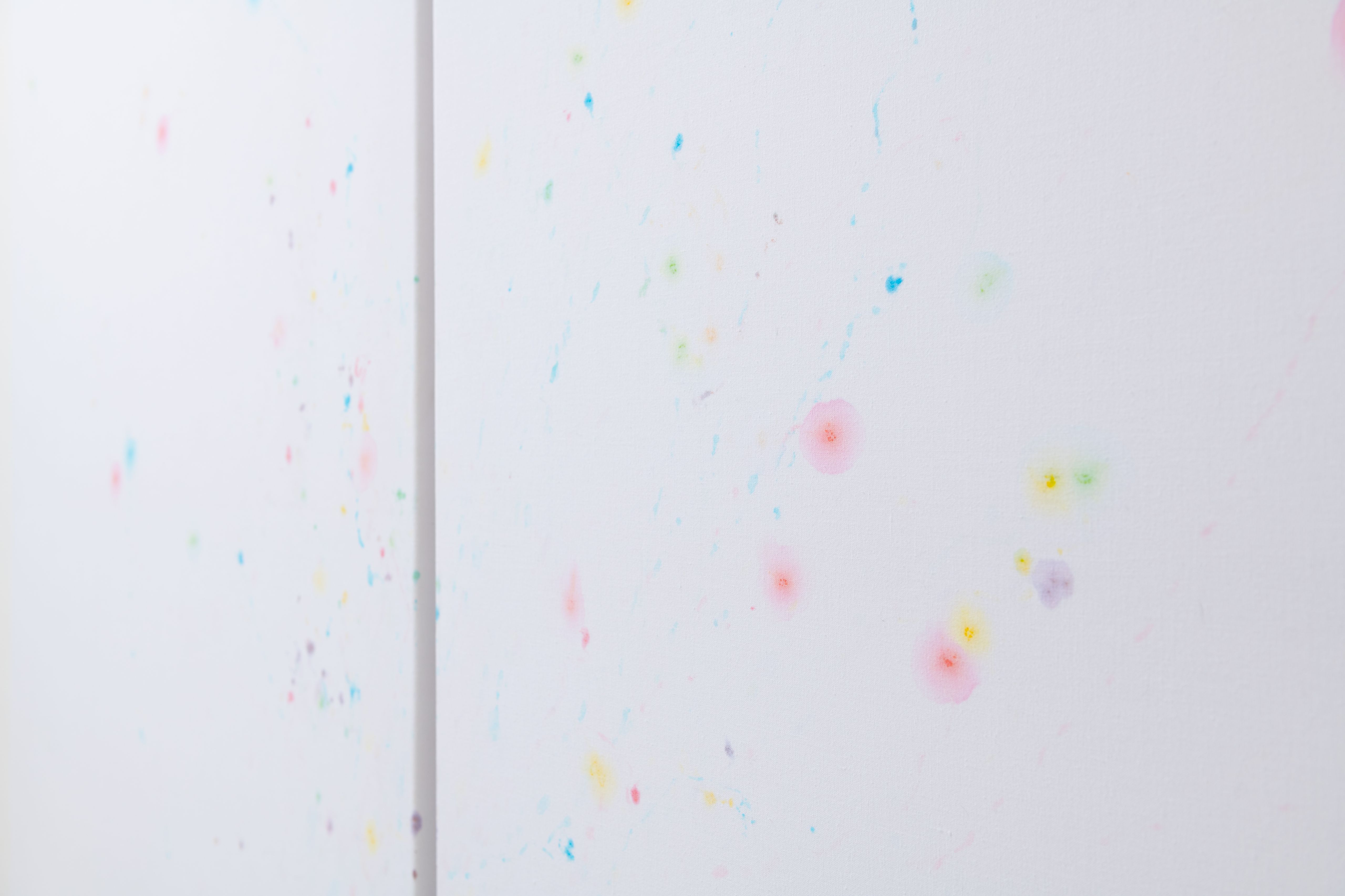 Detail of coloured m&m's stains on white sheets